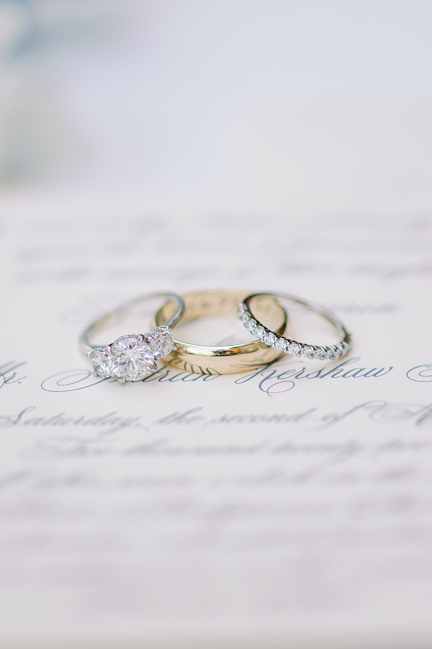 Wedding rings styled on an invitation suite | Photo by Annie Laura Photography