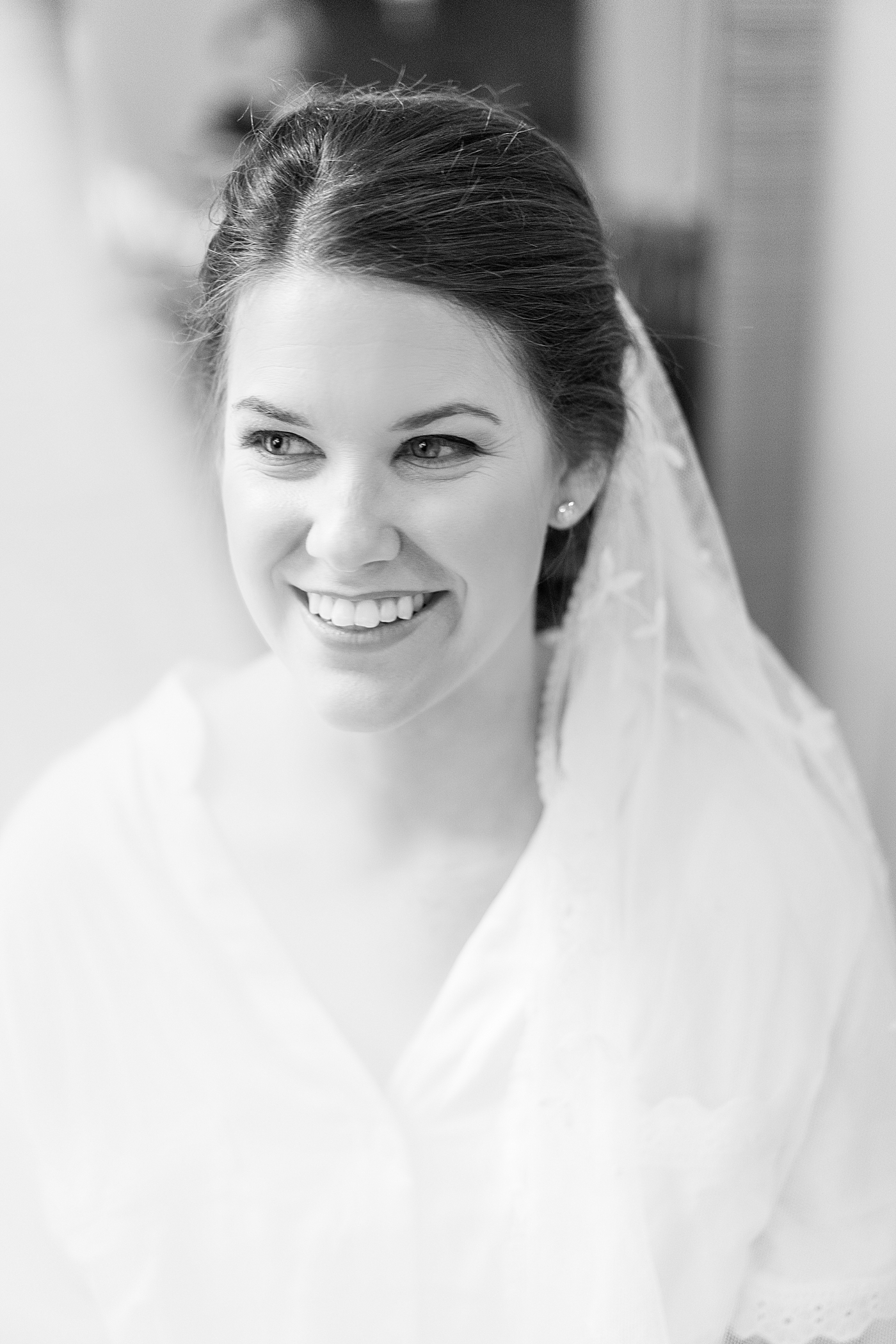 Black and white photo of bride wearing her veil | Photo by Annie Laura Photography