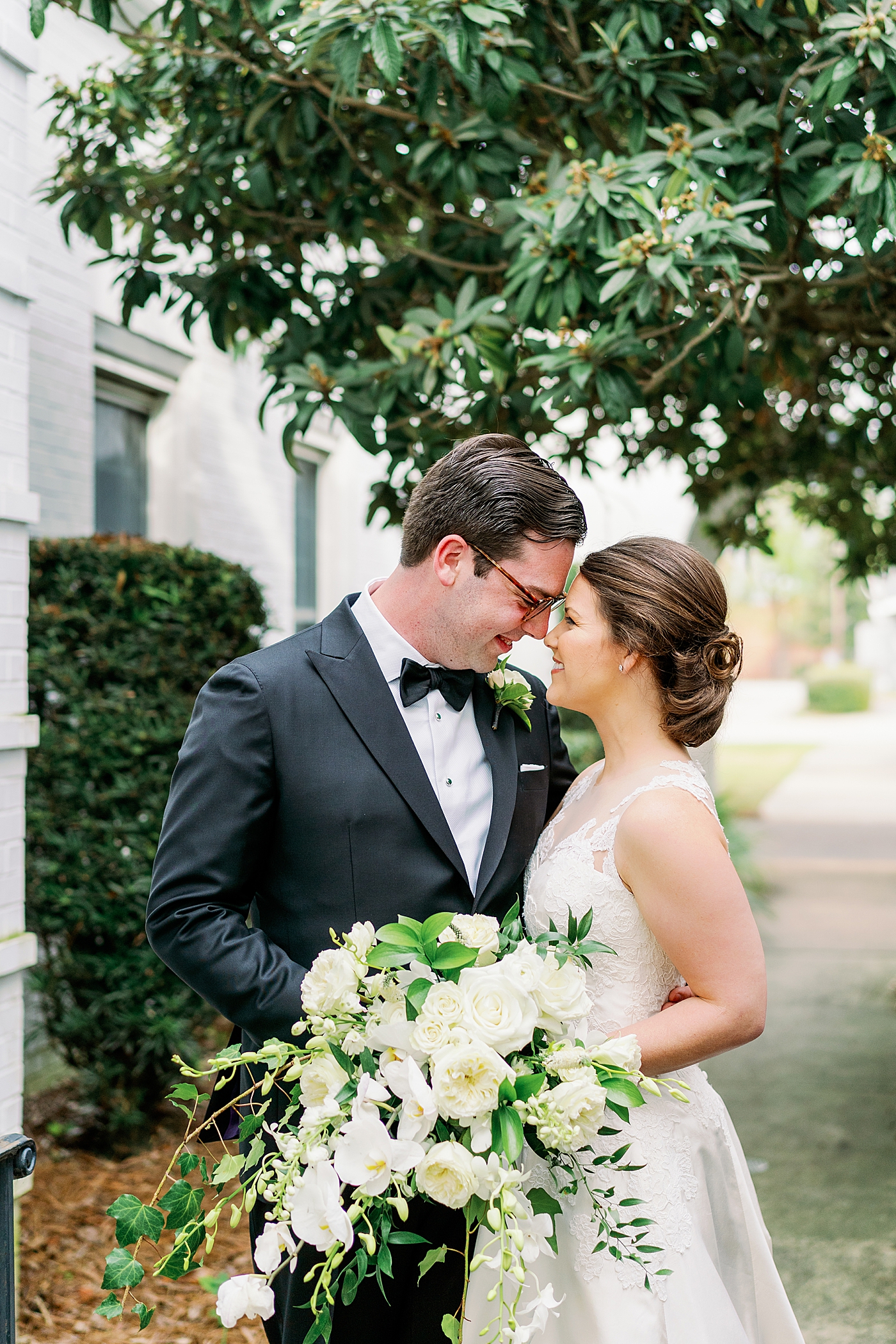 Bride and groom with foreheads together | Photo by Annie Laura Photography