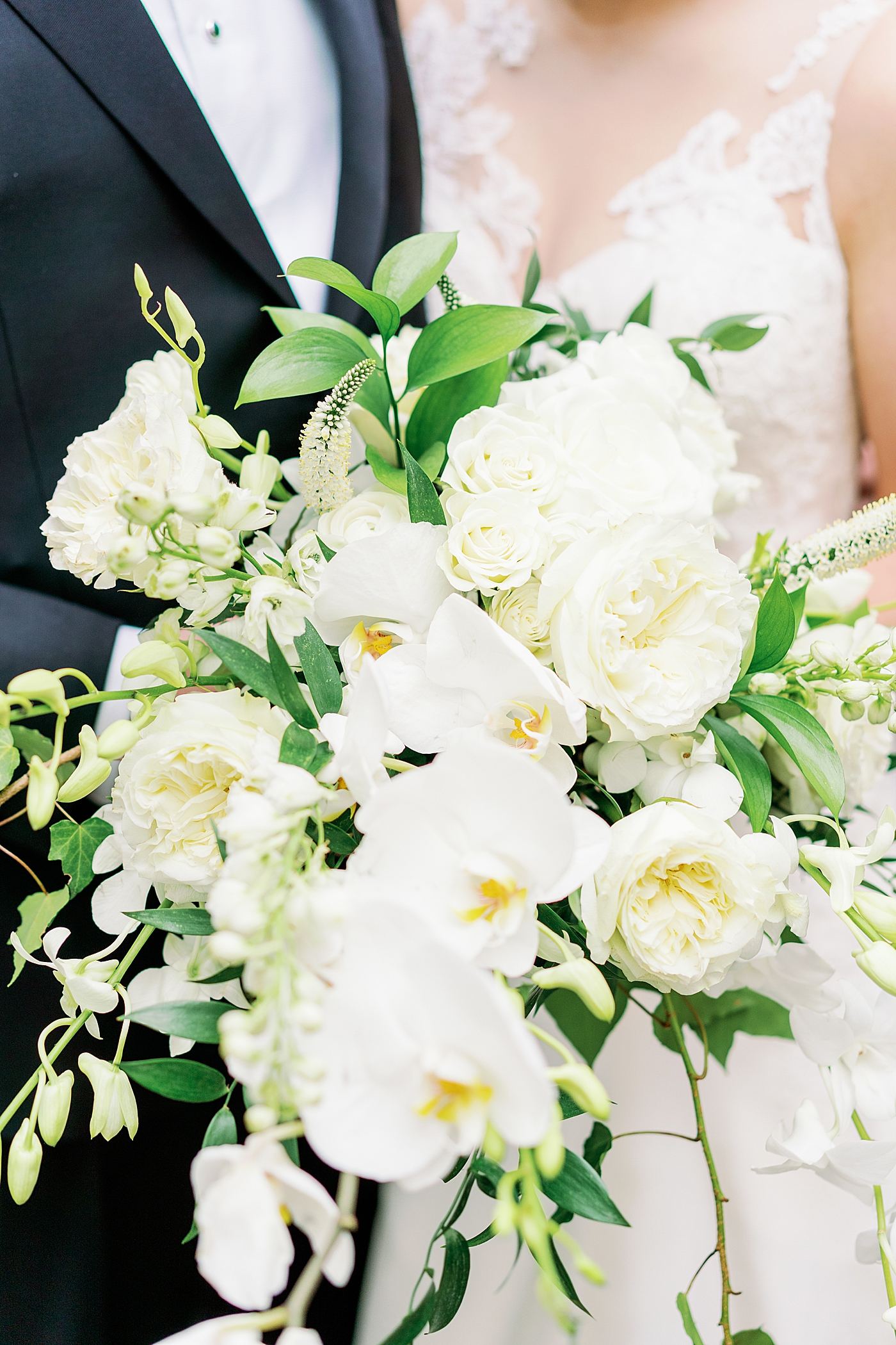 Bridal bouquet with white roses and orchids | Photo by Annie Laura Photography