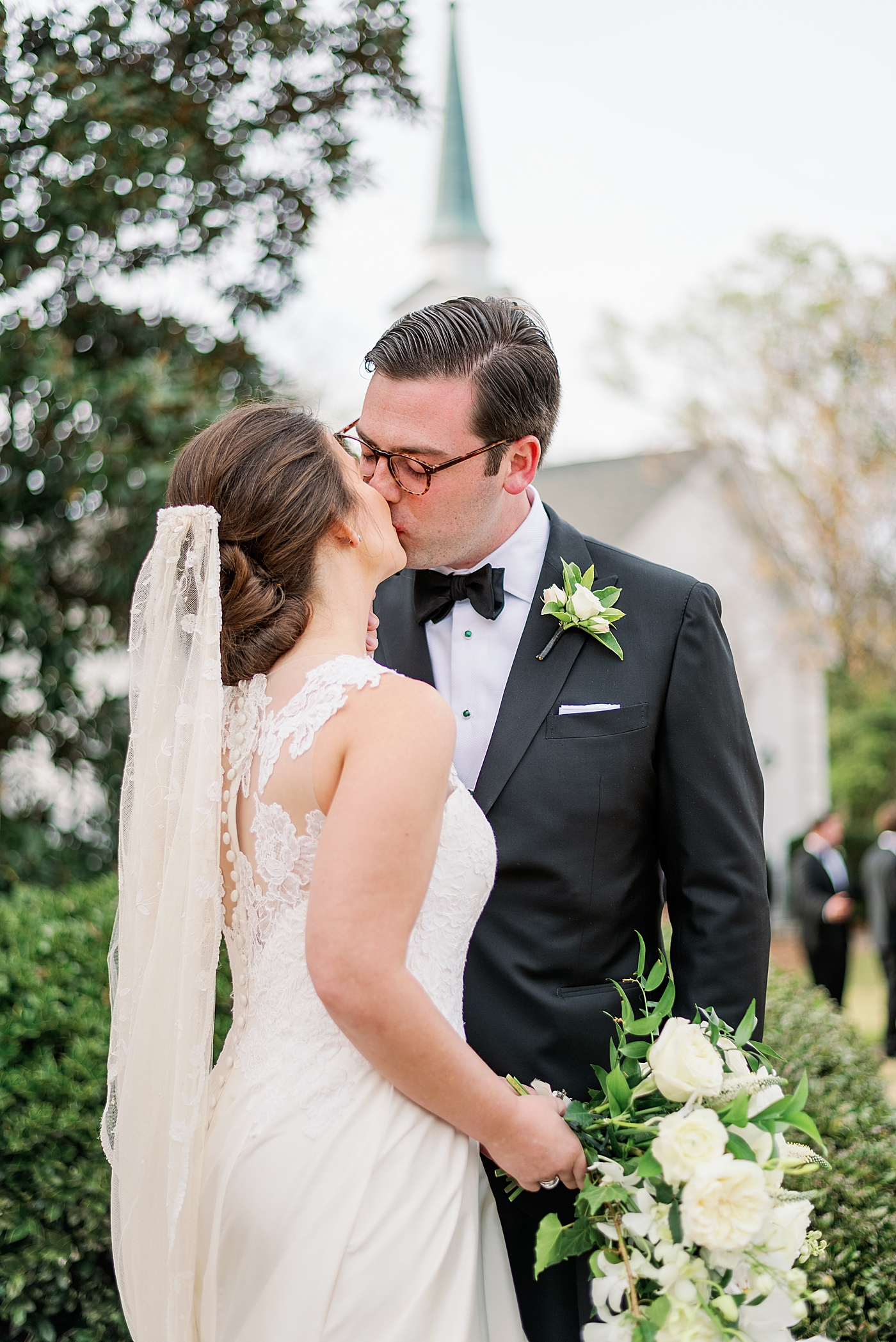 Bride and groom kissing after their wedding | Photo by Annie Laura Photography