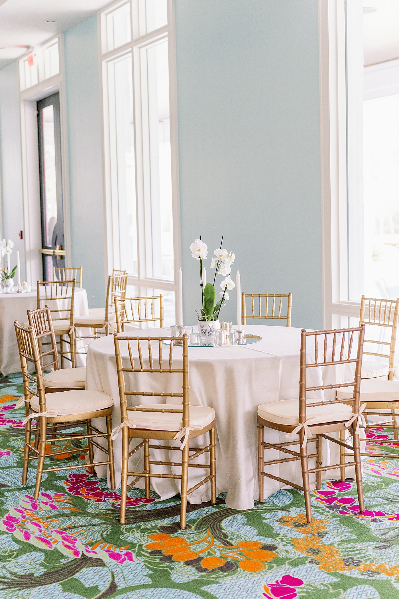 Colorful rug in a light bloom room with gold chairs during Timeless Country Club Wedding | Photo by Annie Laura Photography