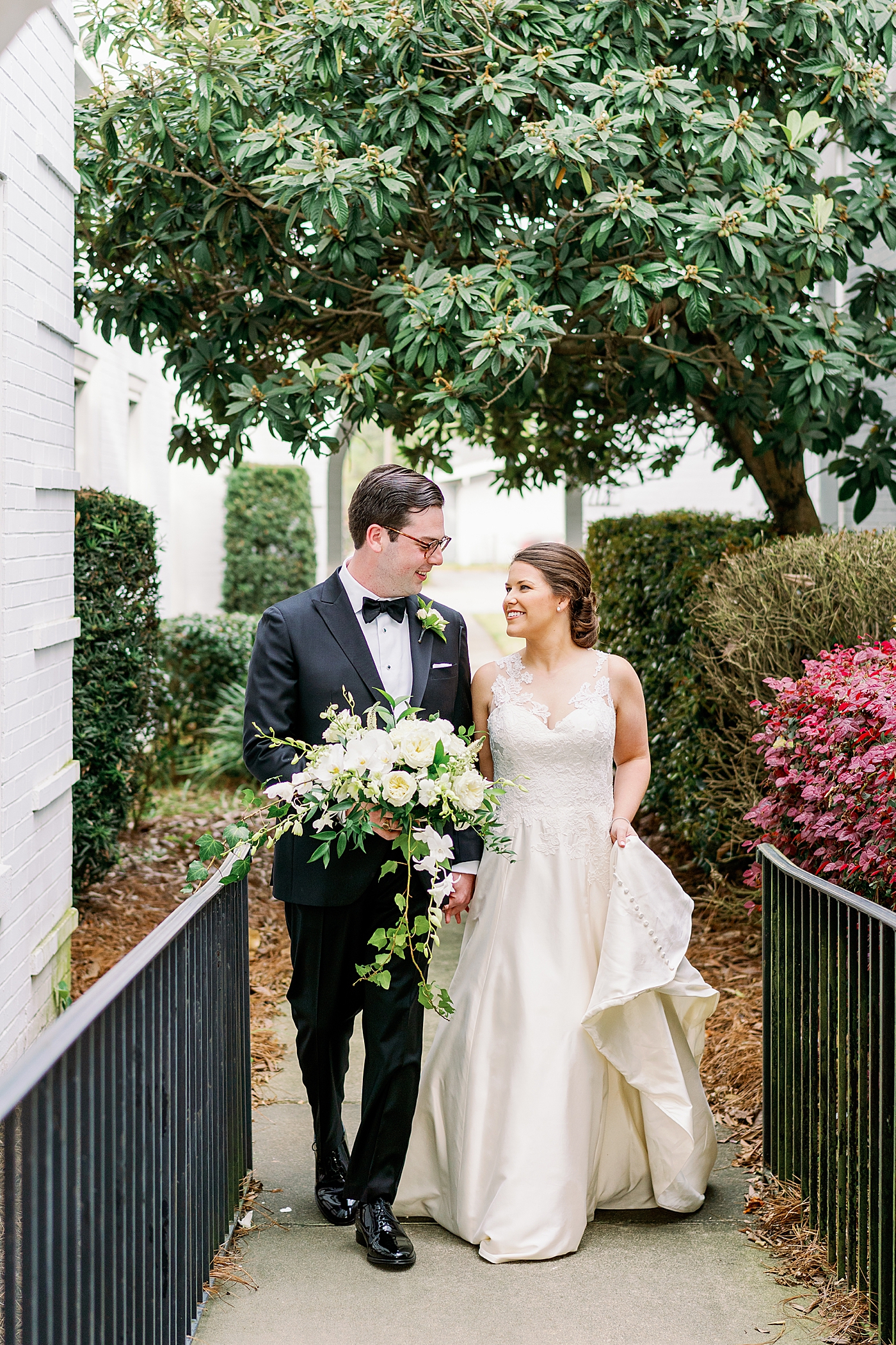 Bride and groom walking together during their Timeless Country Club Wedding | Photo by Annie Laura Photography