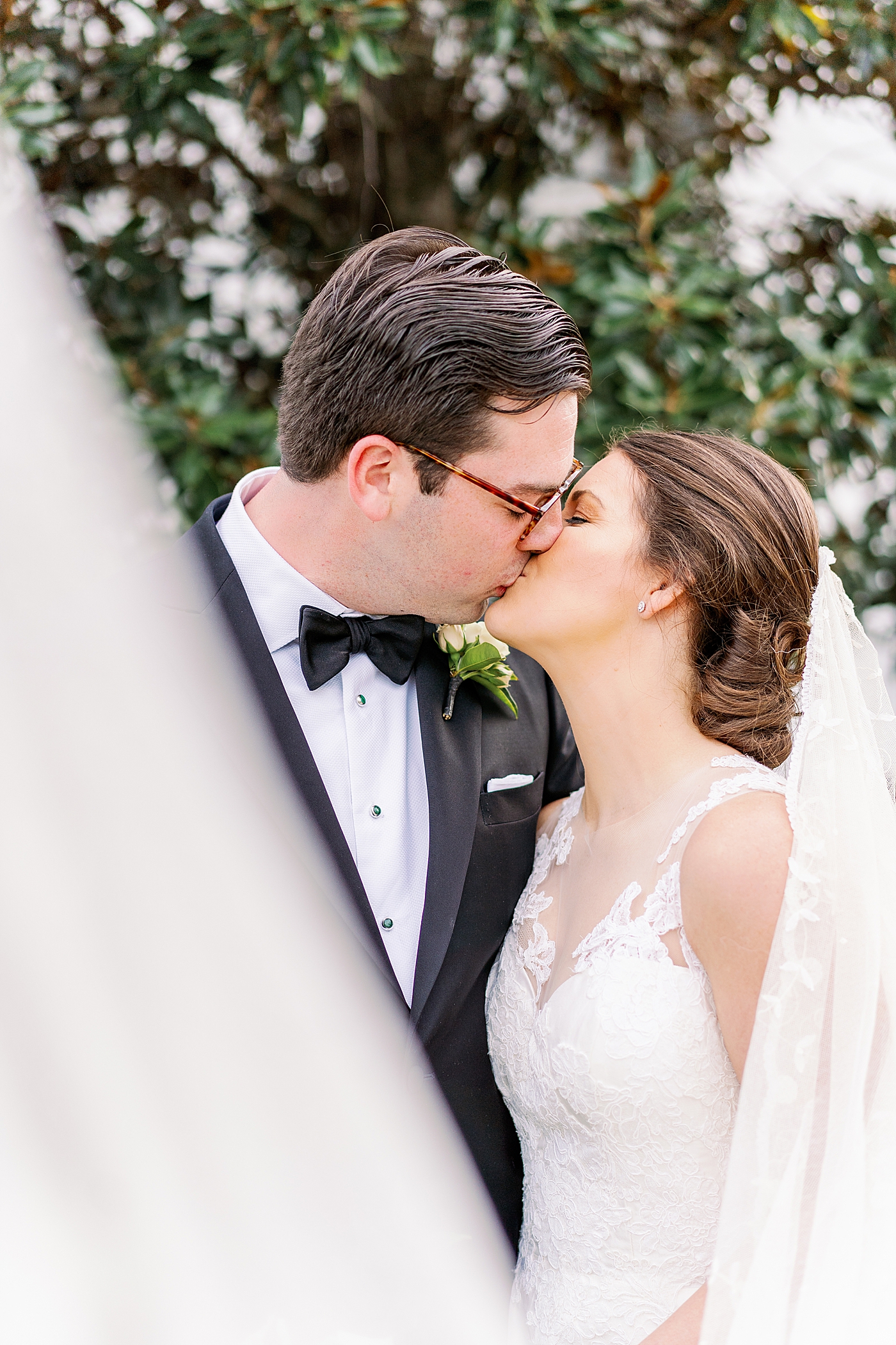Bride and groom kissing behind bride's veil | Photo by Annie Laura Photography