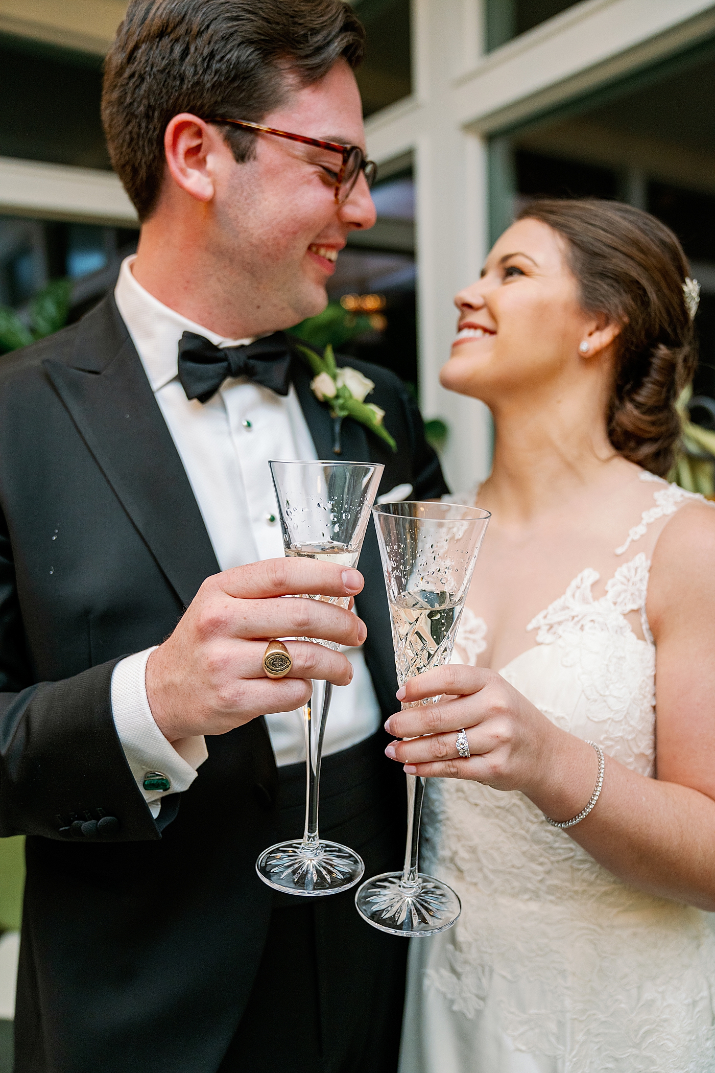 Bride and groom sharing a toast during their Timeless Country Club Wedding| Photo by Annie Laura Photography