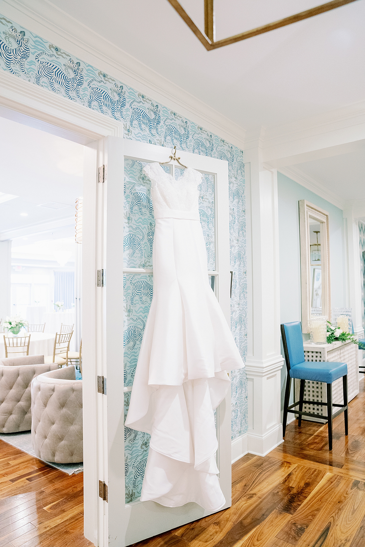 Bride's wedding gown hangin on doorframe | Image by Annie Laura Photo