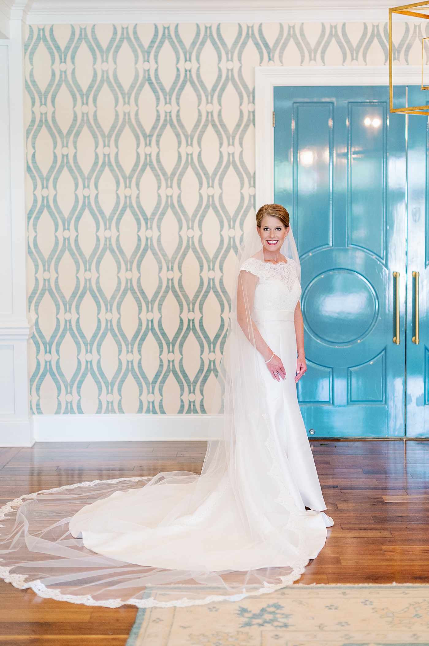 Bride posing for a portrait in her getting ready room | Image by Annie Laura Photo