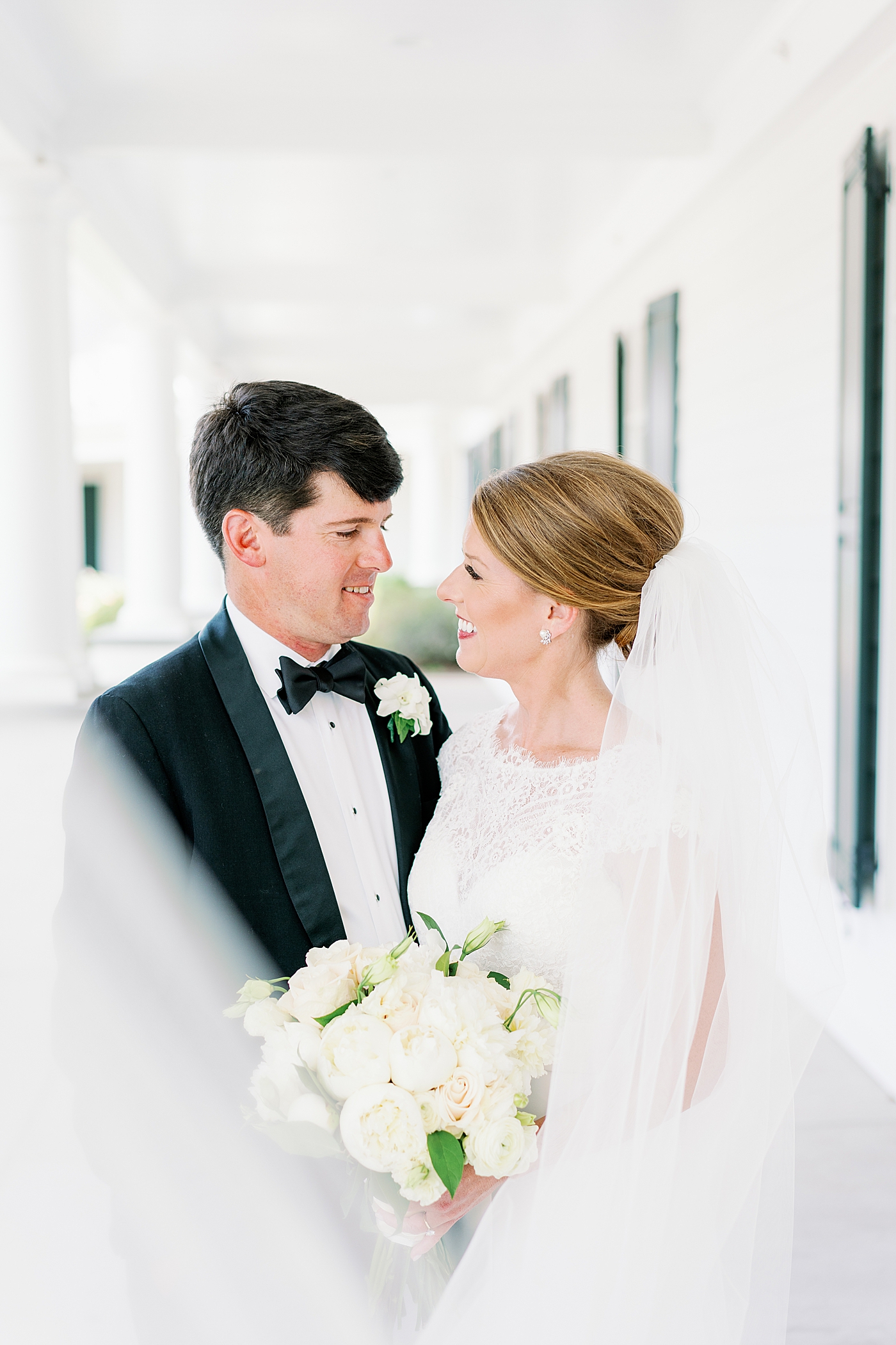 Bride and groom smiling at each other | Image by Annie Laura Photo