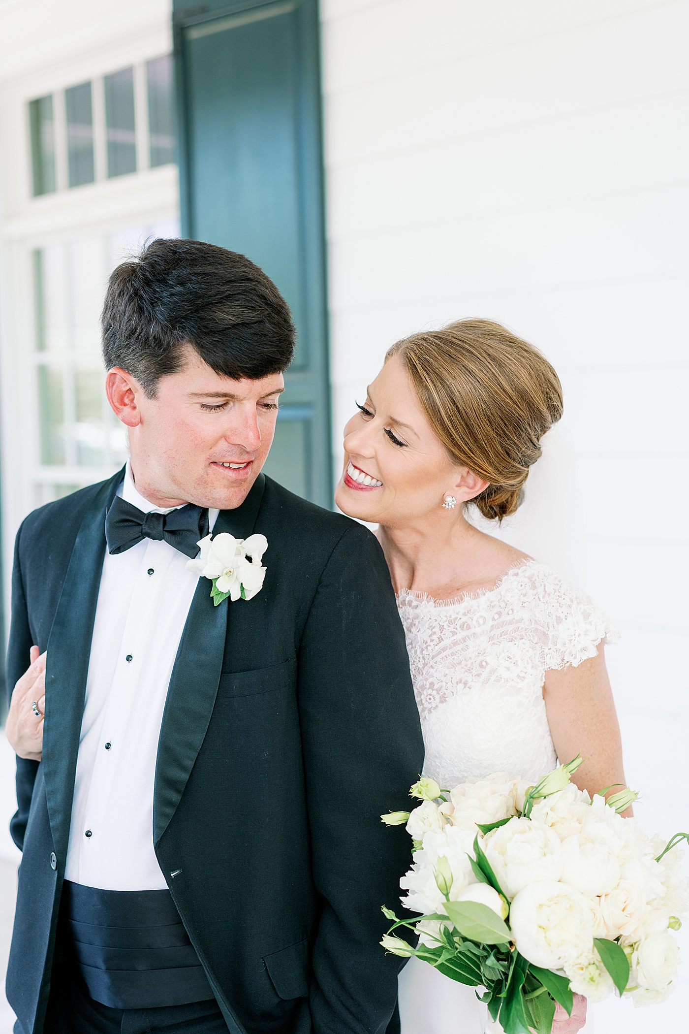 Bride and groom snuggling after their first look in formal attire | Image by Annie Laura Photo