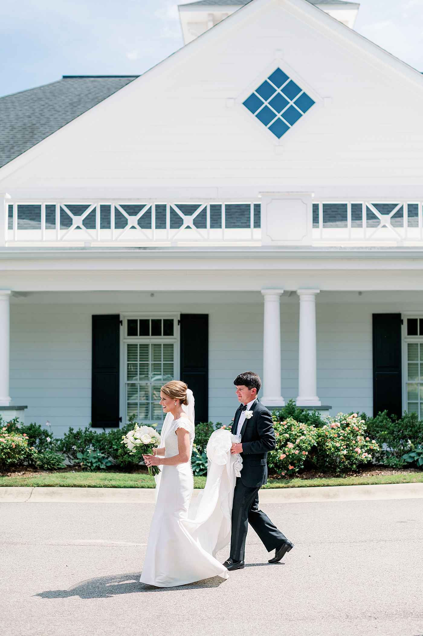 Bride and groom walking toward their wedding party during their Simple Southern Country Club Wedding | Image by Annie Laura Photo