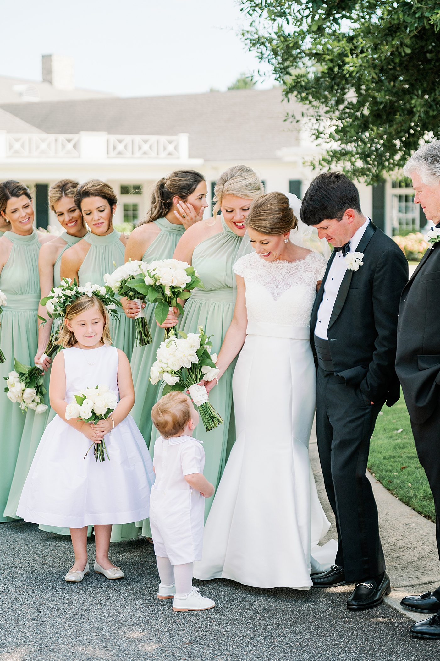 Bride and groom interacting with flower girl and ring bearer | Image by Annie Laura Photo