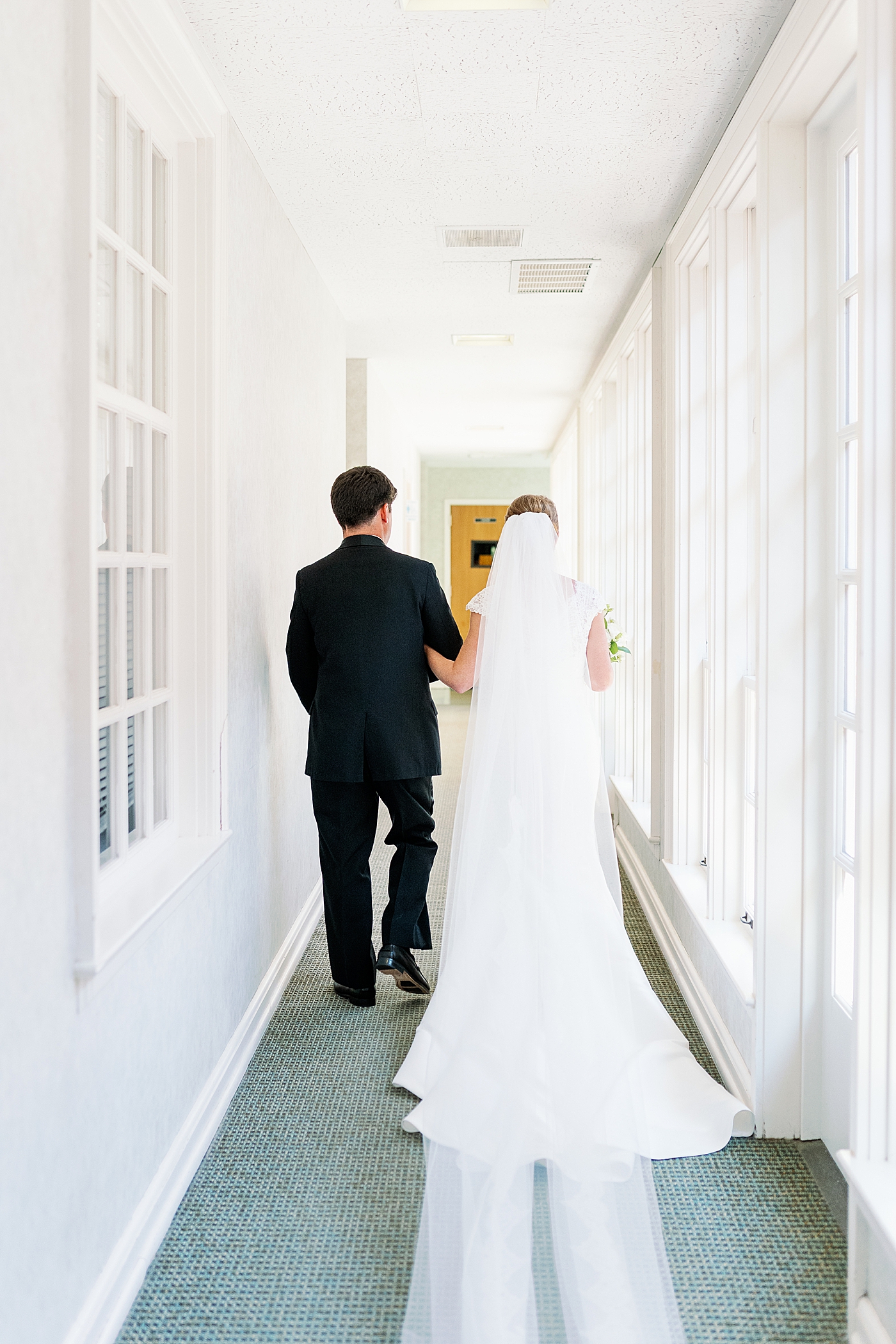 Bride and groom in a hallway after their wedding | Image by Annie Laura Photo