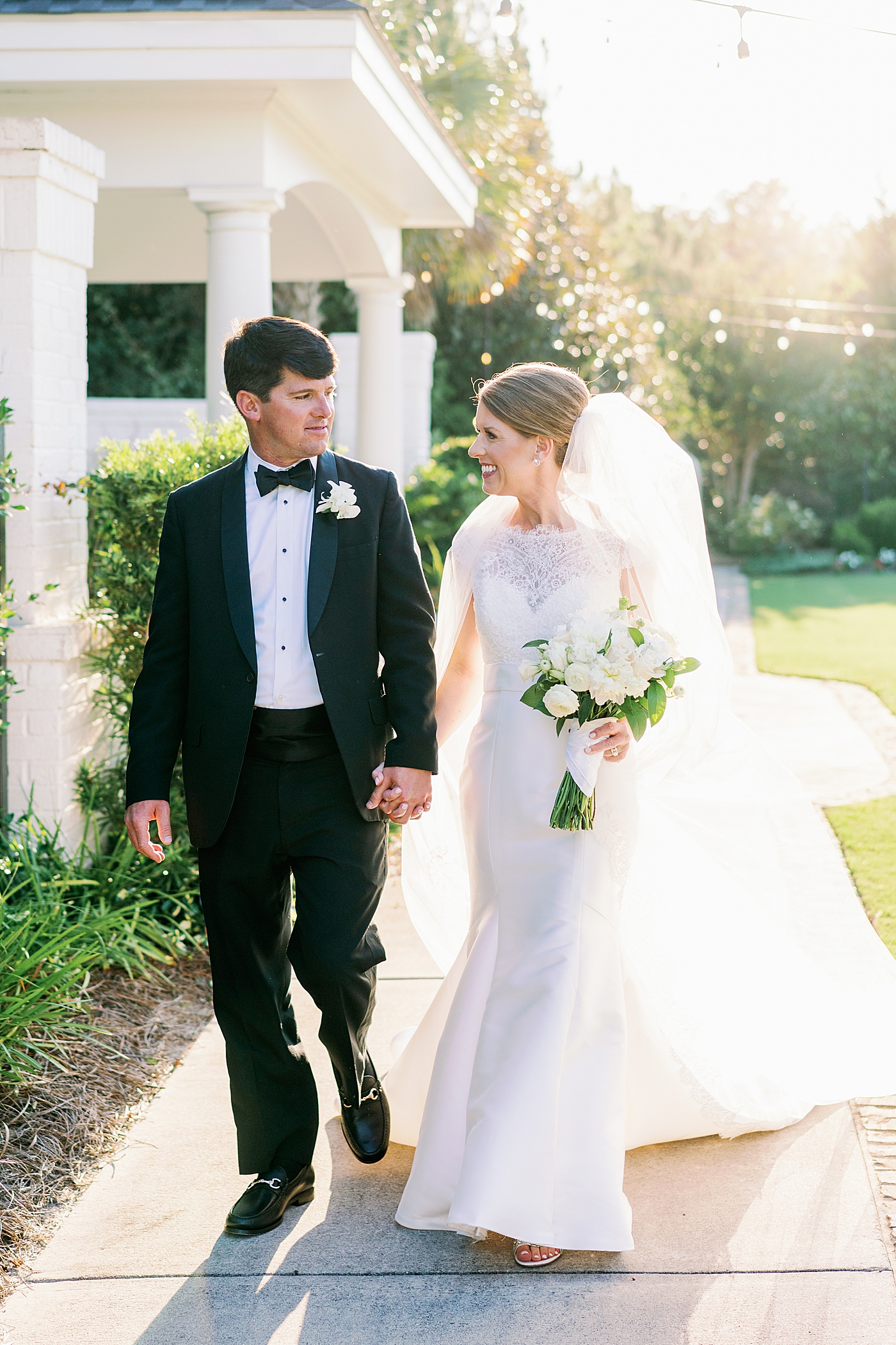 Bride and groom walking hand in hand at sunset | Image by Annie Laura Photo
