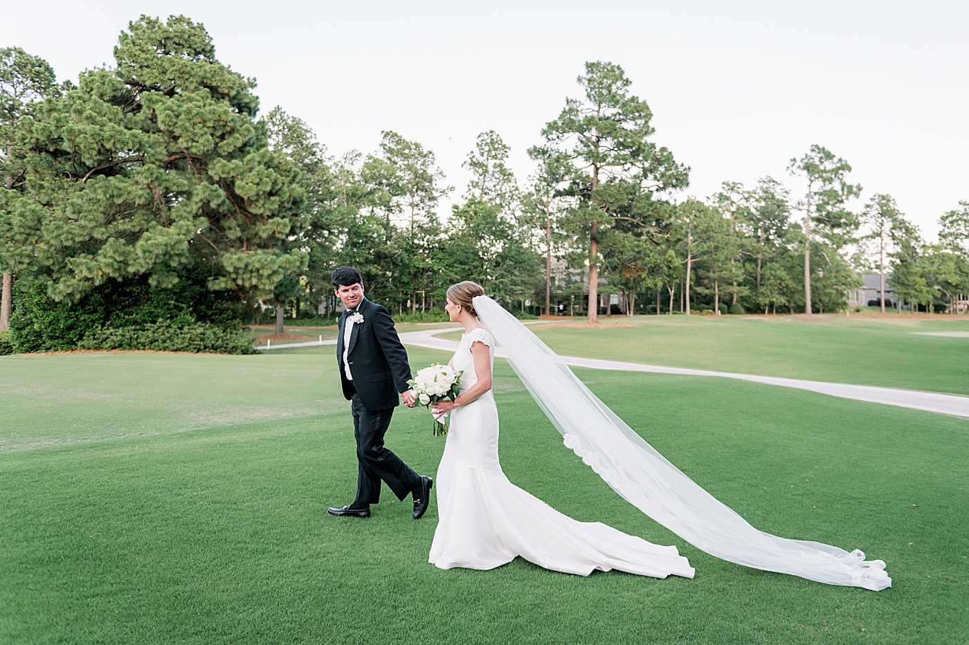 Bride and groom walking hand in hand | Image by Annie Laura Photo