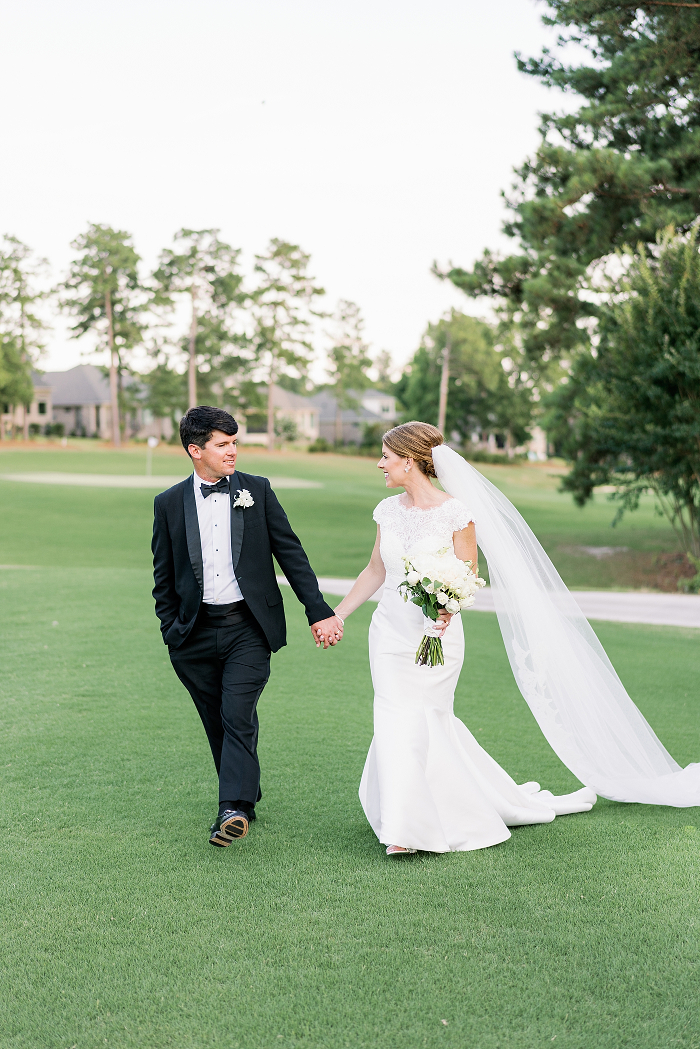 Bride and groom walking to their reception after their Simple Southern Country Club Wedding | Image by Annie Laura Photo