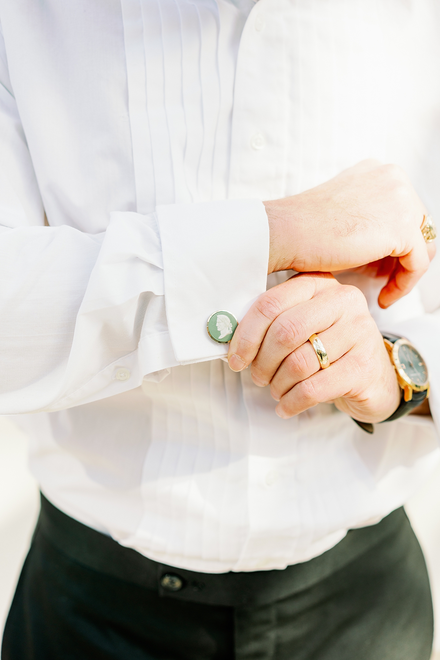 Groom adjusting green antique cufflinks before summer inspired garden wedding| Photo by Annie Laura Photo