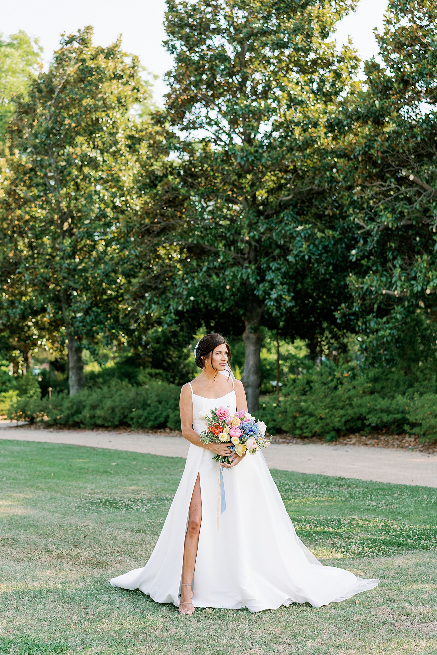 Bride holding colorful bouquet | Photo by Annie Laura Photo