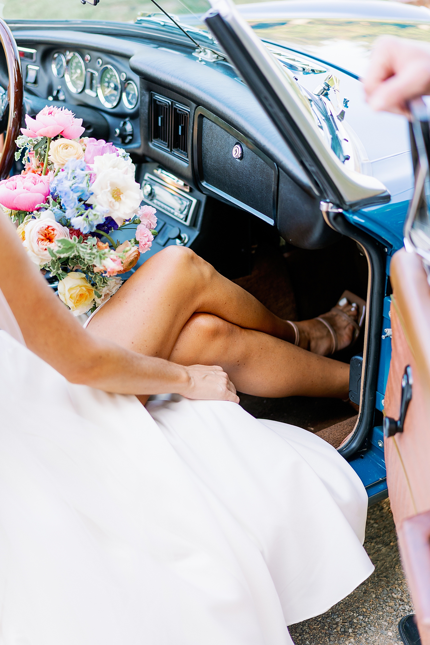  Detail of bride sitting in antique car at Boyd Foundation Horticultural Center| Photo by Annie Laura Photo