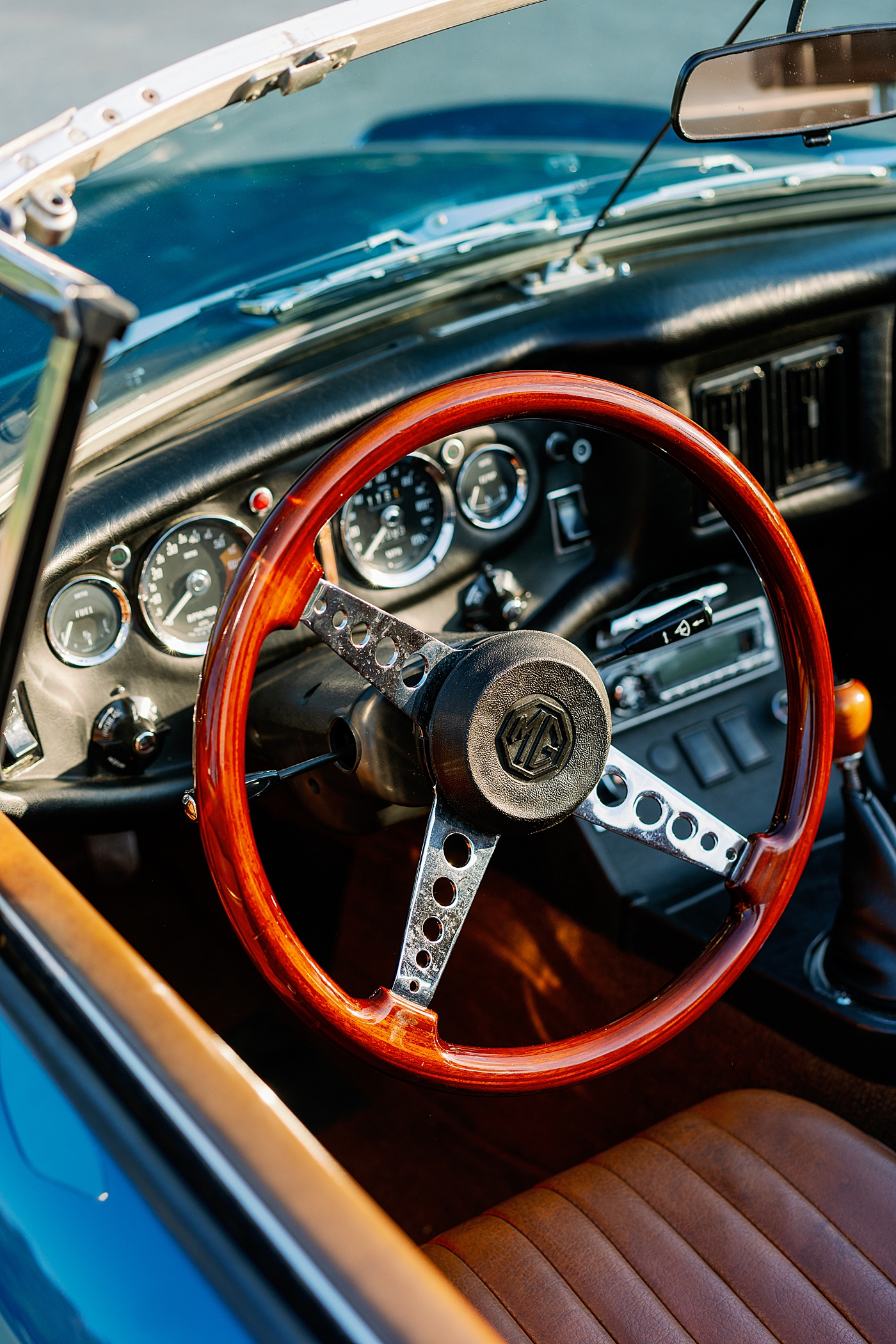  Detail of steering wheel of blue antique car | Photo by Annie Laura Photo