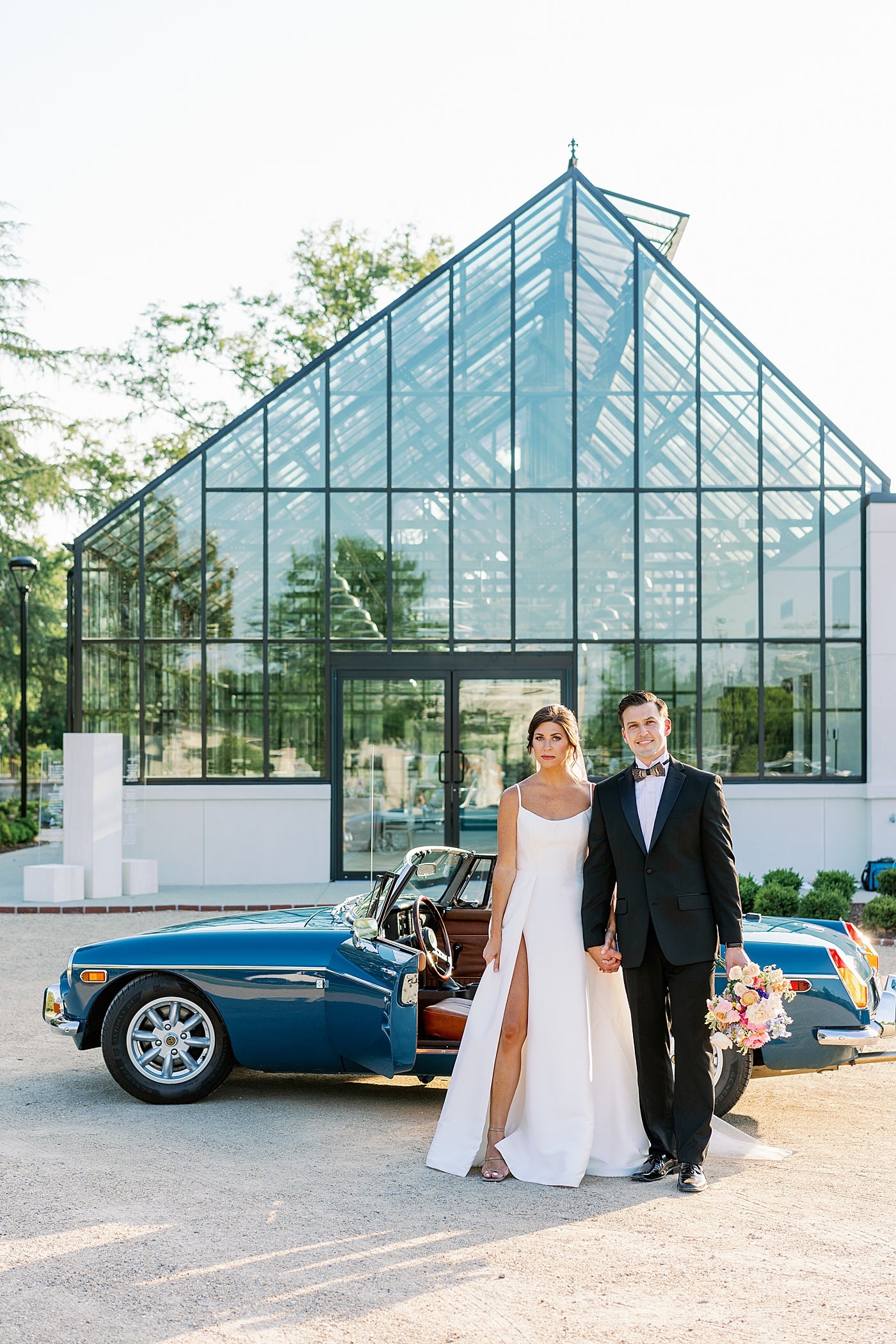 Bride and groom standing in front of Boyd Foundation Horticultural Center | Photo by Annie Laura Photo