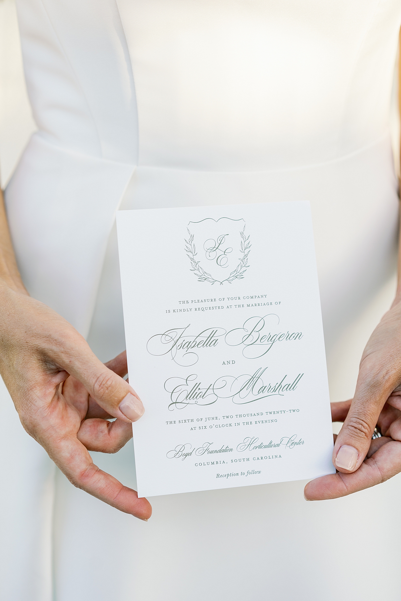 Detail of bride holding wedding invitation | Photo by Annie Laura Photo