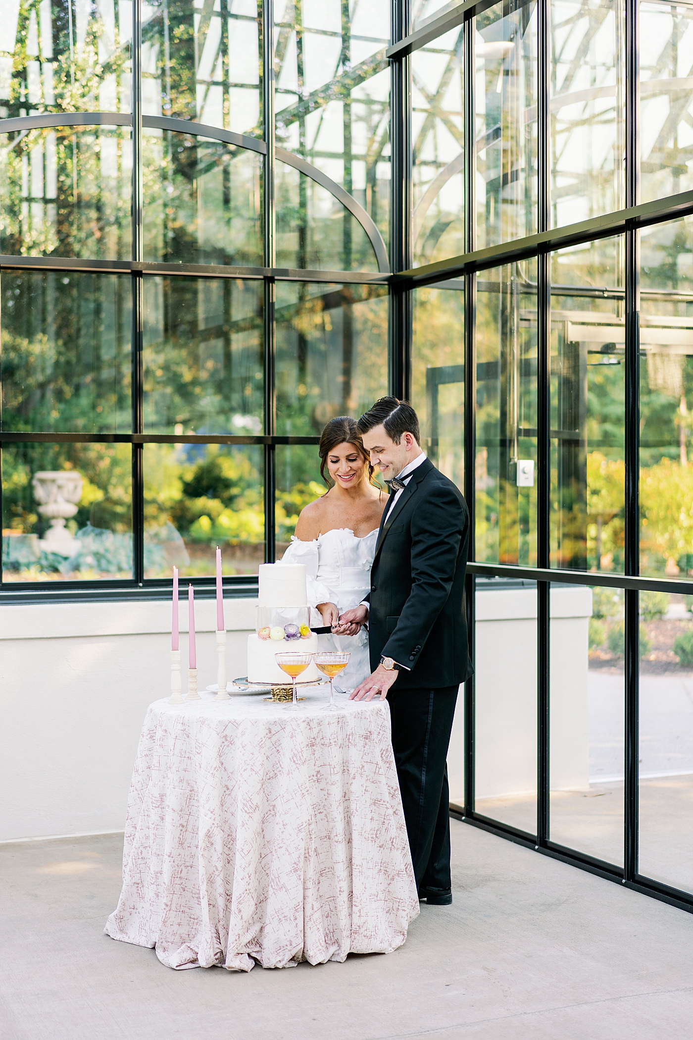 Bride and groom cutting their cake during summer inspired garden wedding | Photo by Annie Laura Photo