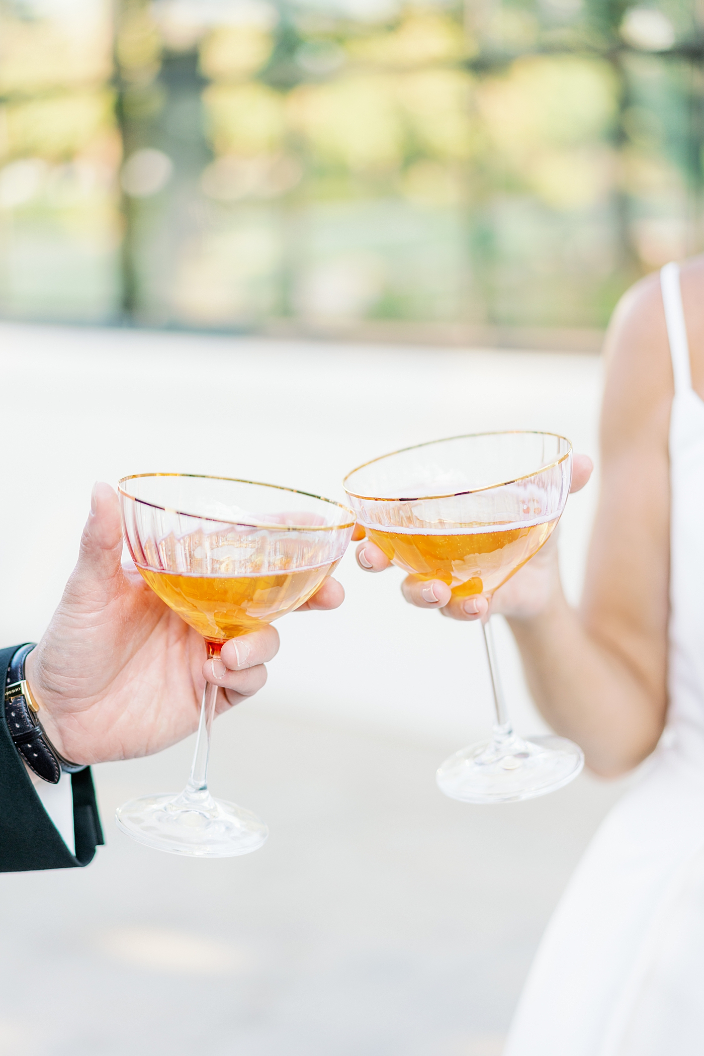 Custom gold rimmed champagne coupes with champagne | Photo by Annie Laura Photo