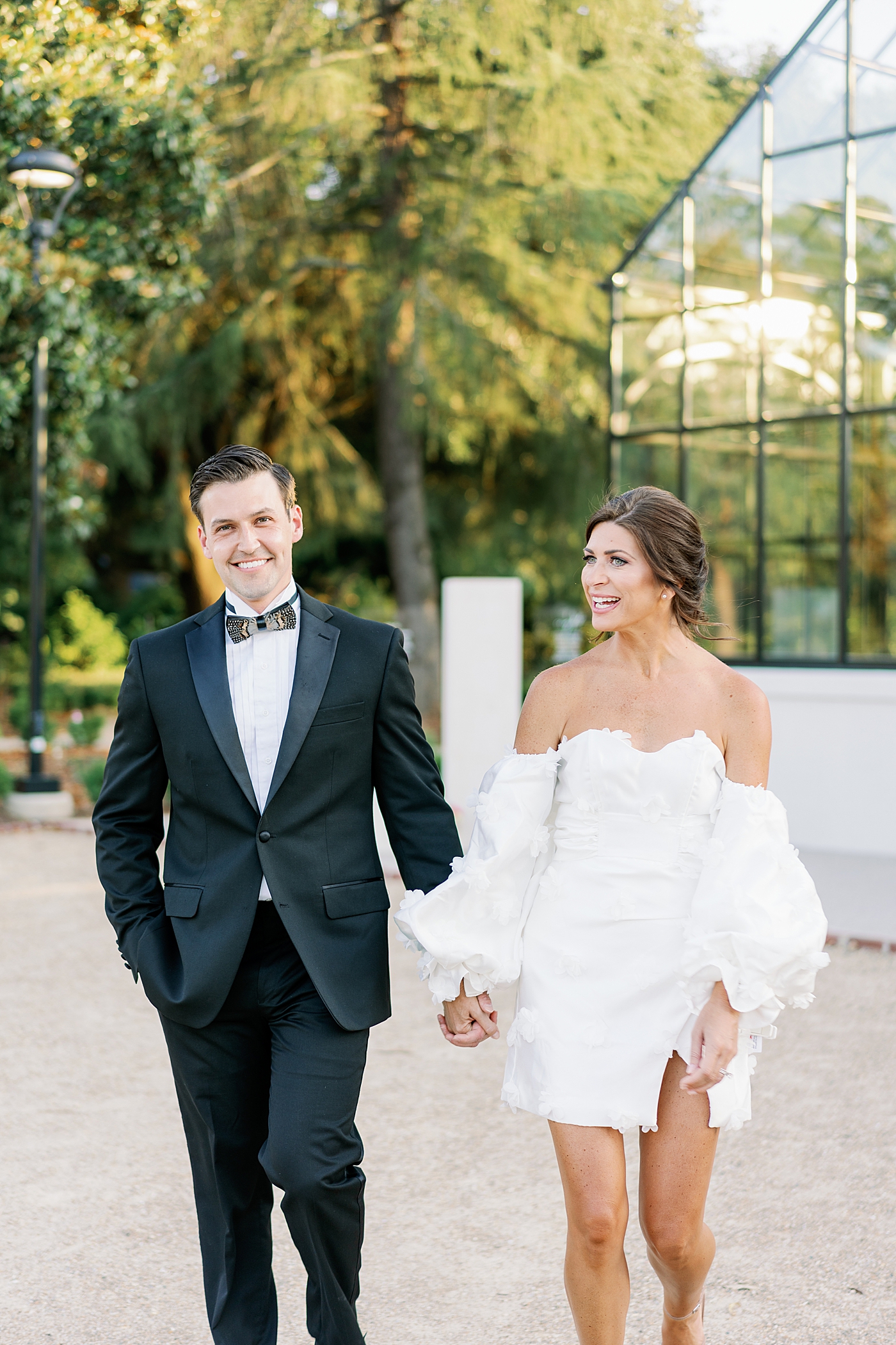 Bride and groom walking holding hands | Photo by Annie Laura Photo
