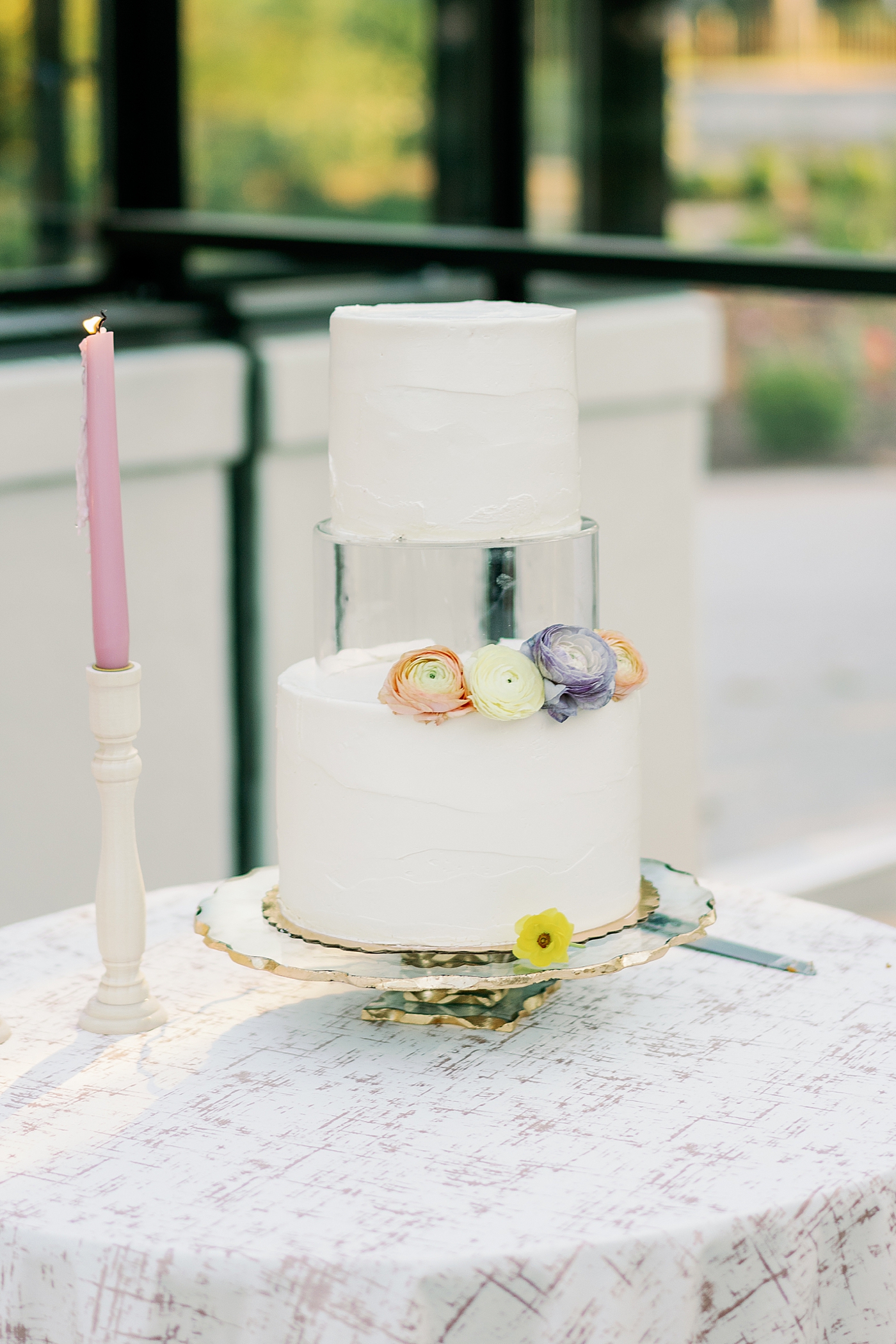 Cake with pink pillar candles during summer inspired garden wedding | Photo by Annie Laura Photo