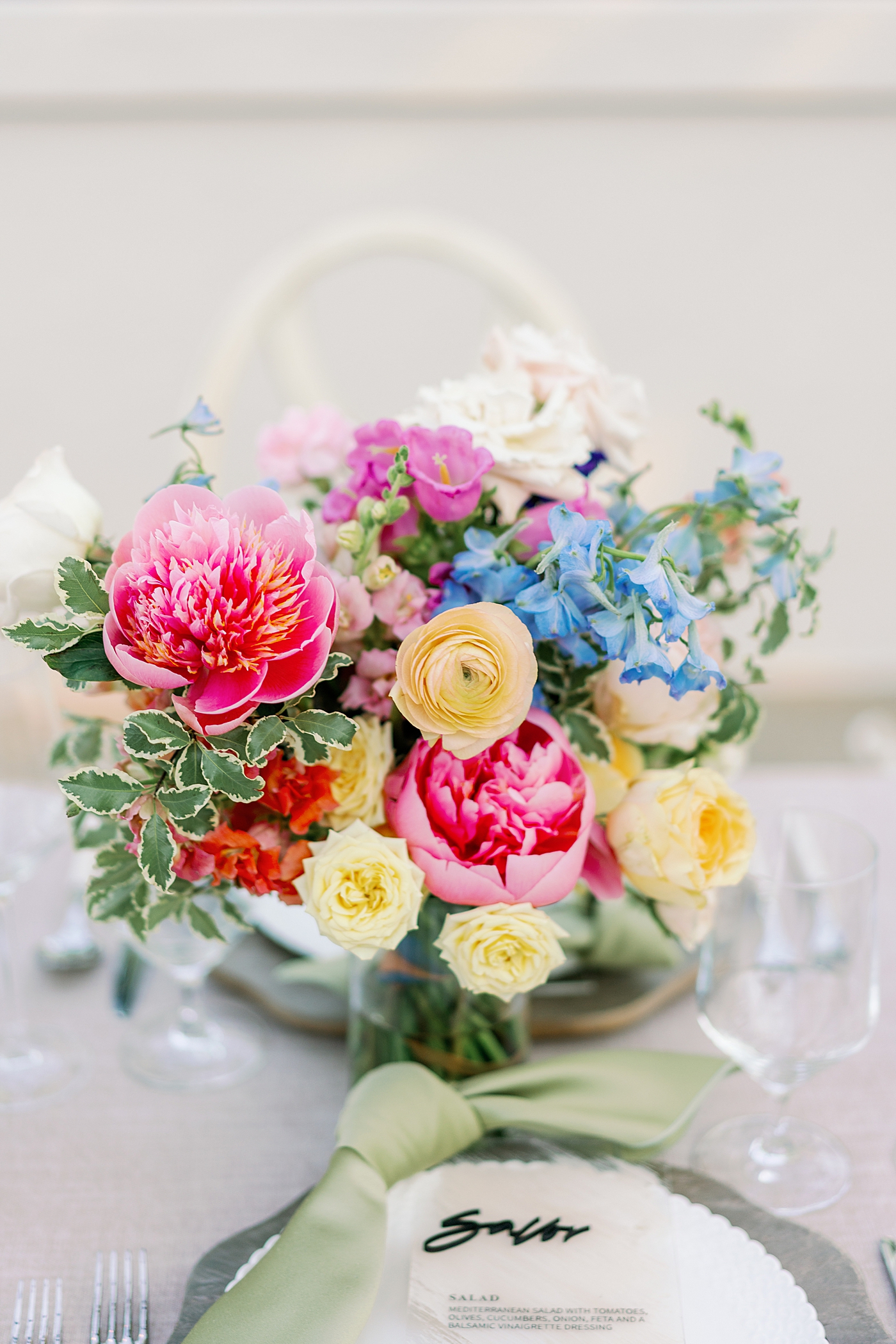 Table setting during summer inspired garden wedding with bright florals | Photo by Annie Laura Photo