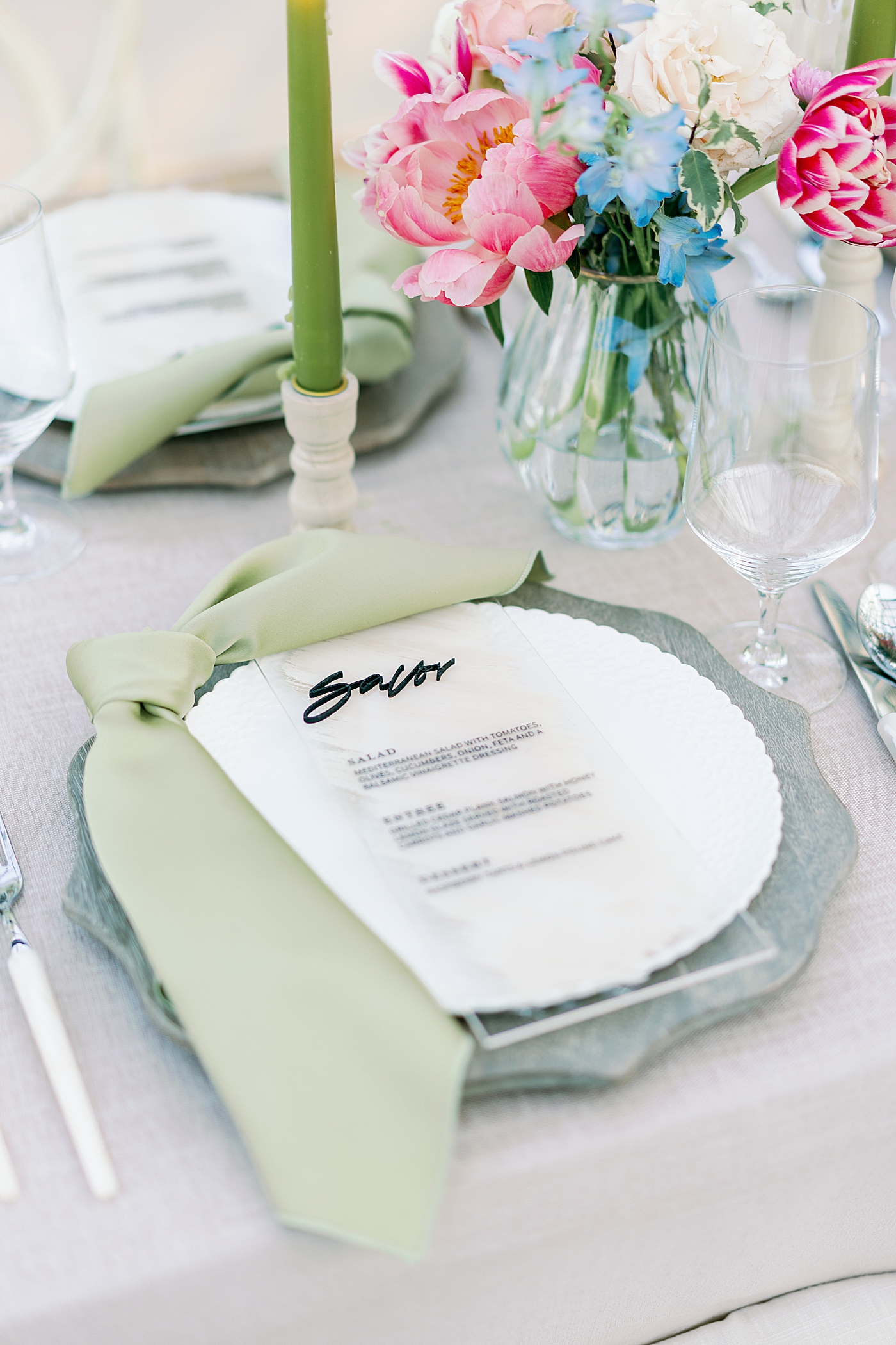 Custom menu and table setting with green pillar candles | Photo by Annie Laura Photo
