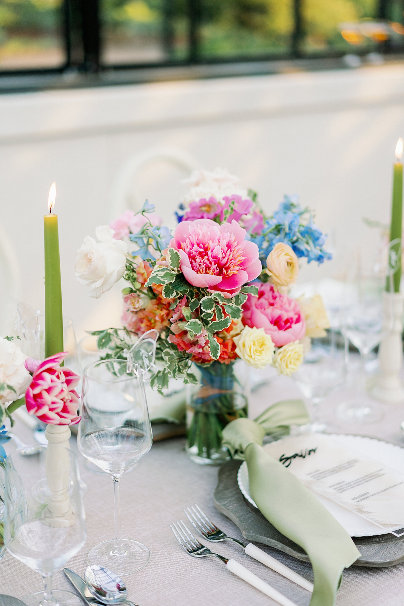 Table setting with colorful florals during summer inspired garden wedding| Photo by Annie Laura Photo