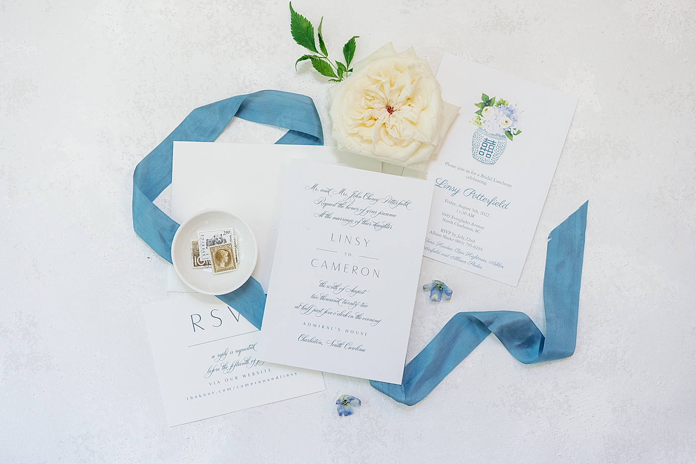 Wedding invitation suite with blue ribbon and white flowers | Images by Annie Laura Photography