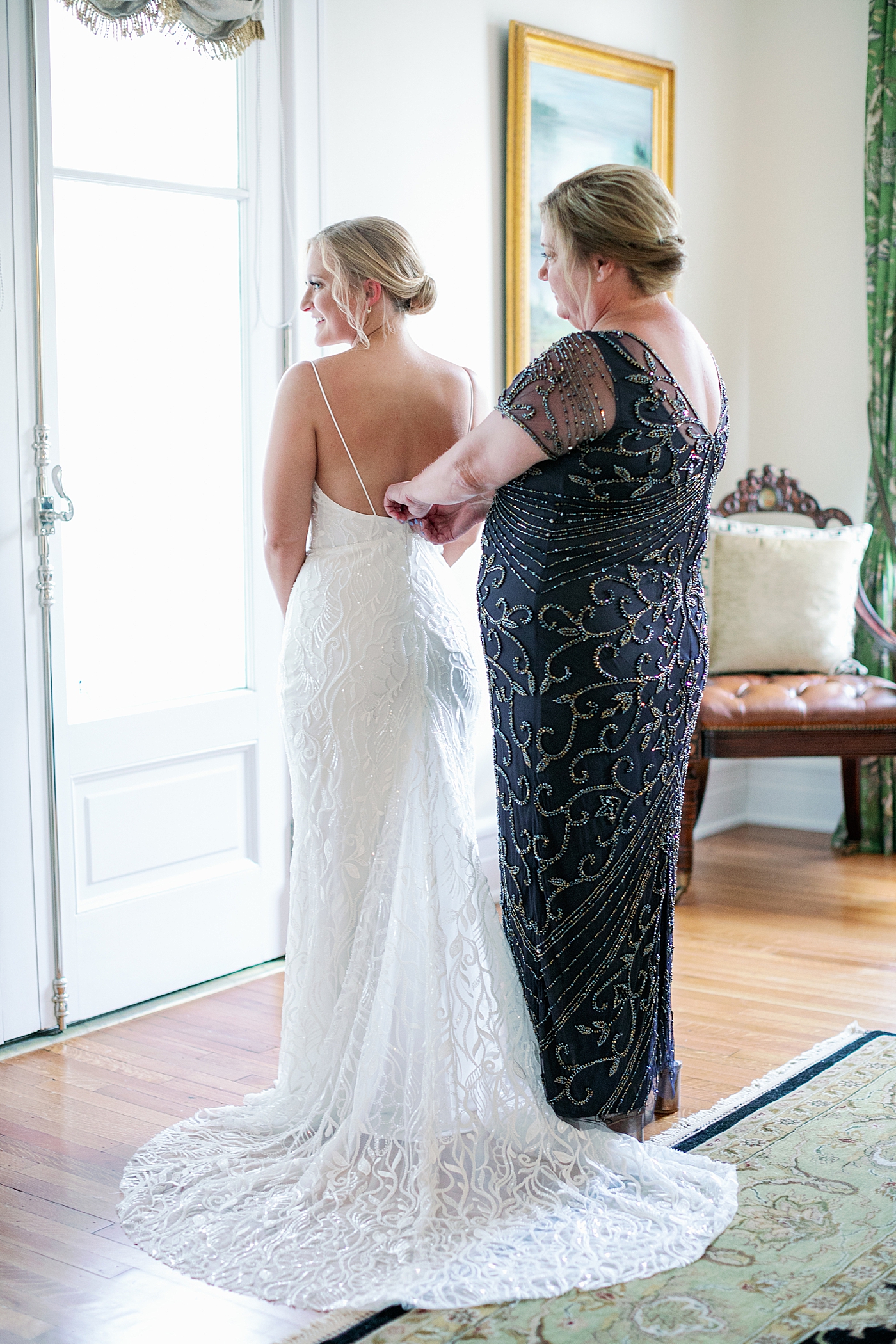 Bride being helped into her dress | Images by Annie Laura Photography