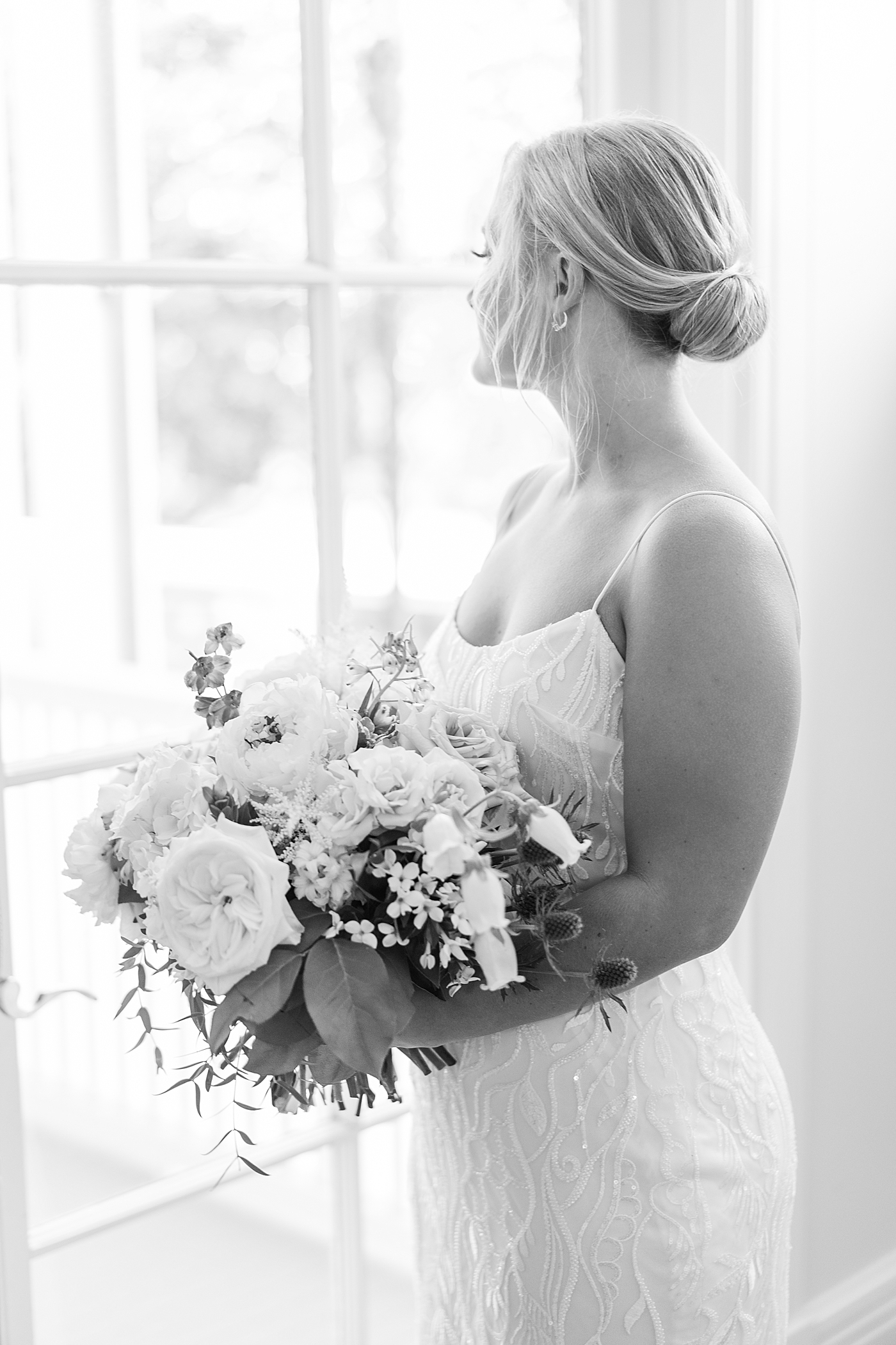 Black and white image of bride near the window | Images by Annie Laura Photography