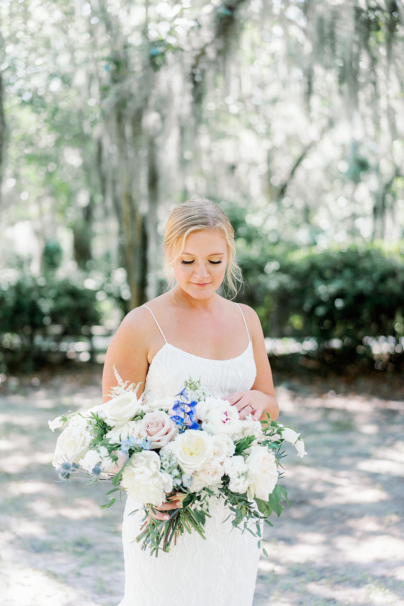 Bride holding her bouquet during Elegant Grandmillenial Charleston Wedding | Images by Annie Laura Photography