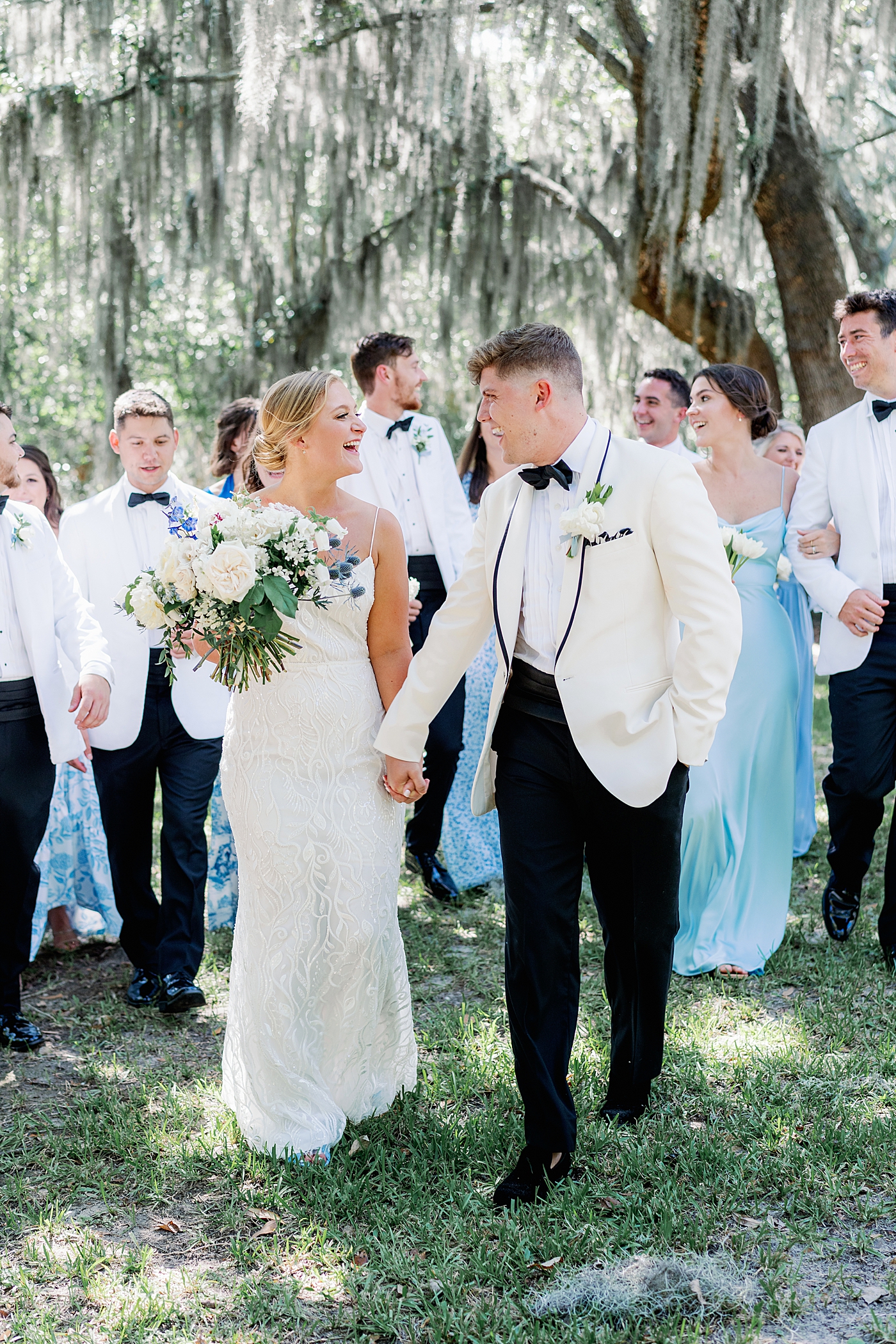 Bride and groom laughing with their wedding party | Images by Annie Laura Photography