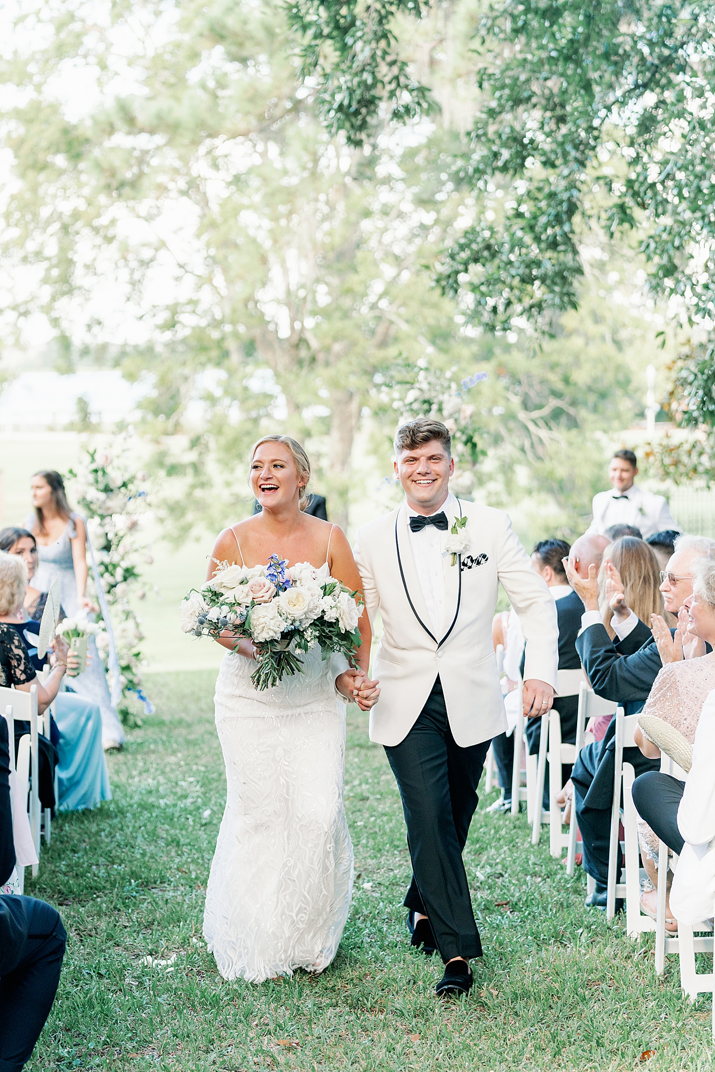 Bride and groom walking down the aisle during their Elegant Grandmillenial Charleston Wedding | Images by Annie Laura Photography