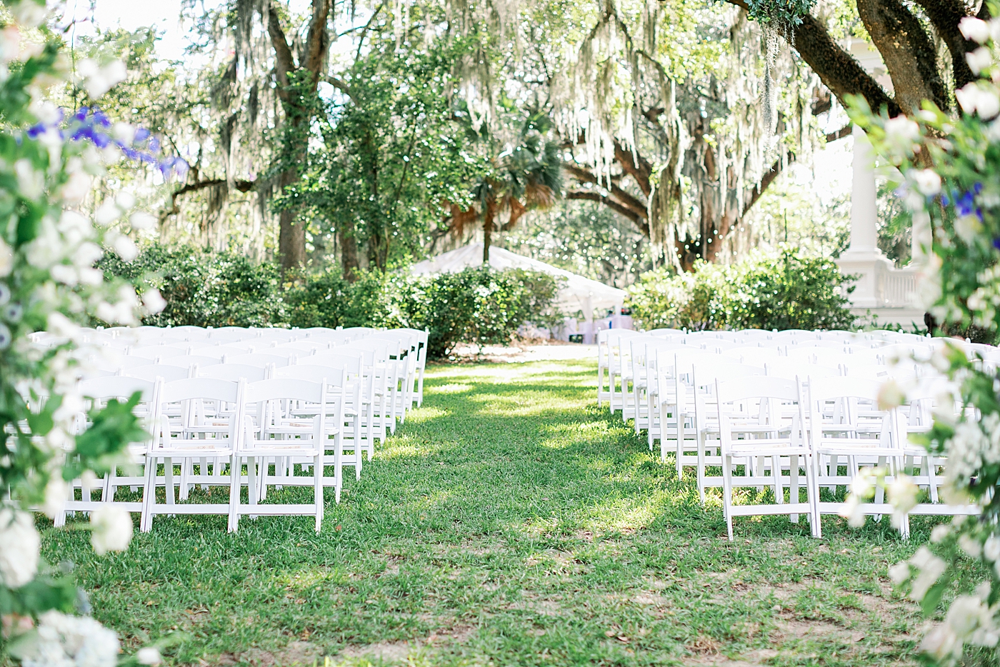 Wedding ceremony setup with white chairs | Images by Annie Laura Photography