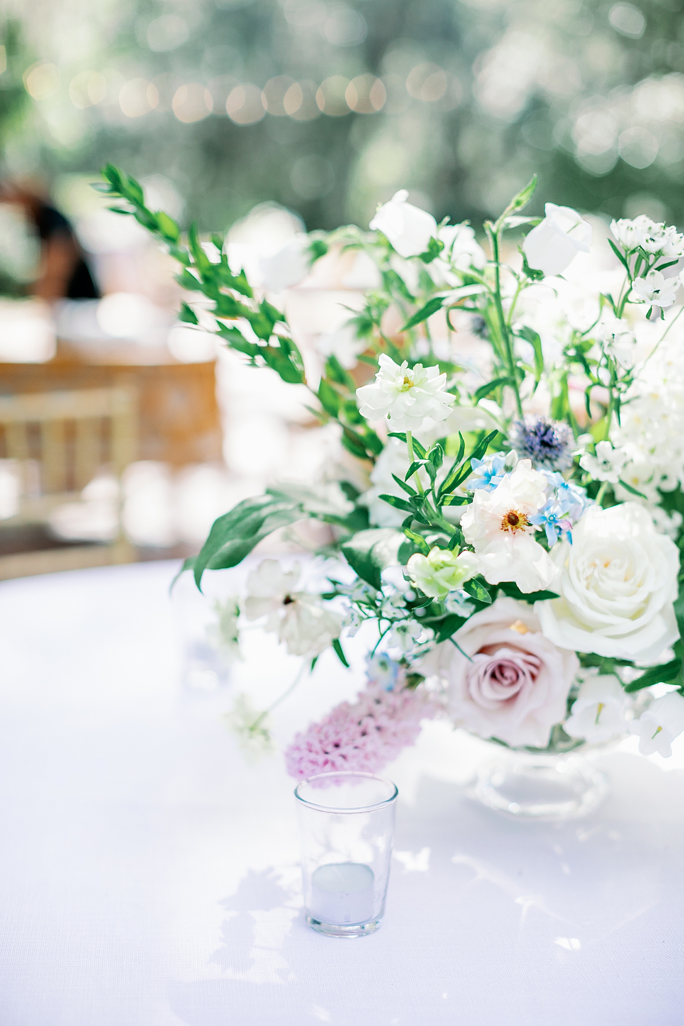 Reception details with votives and flowers during Elegant Grandmillenial Charleston Wedding | Images by Annie Laura Photography