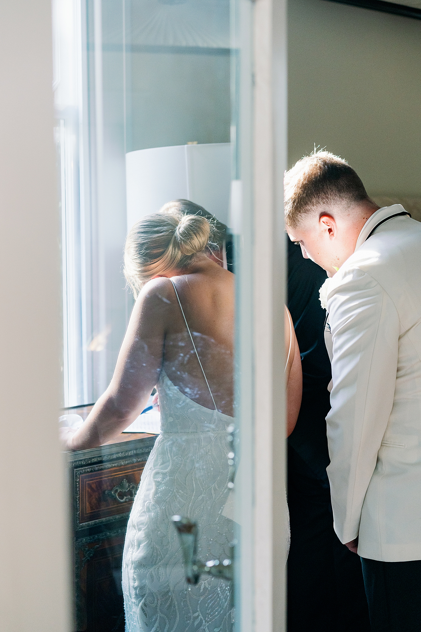 Bride and groom signing their marriage license | Images by Annie Laura Photography