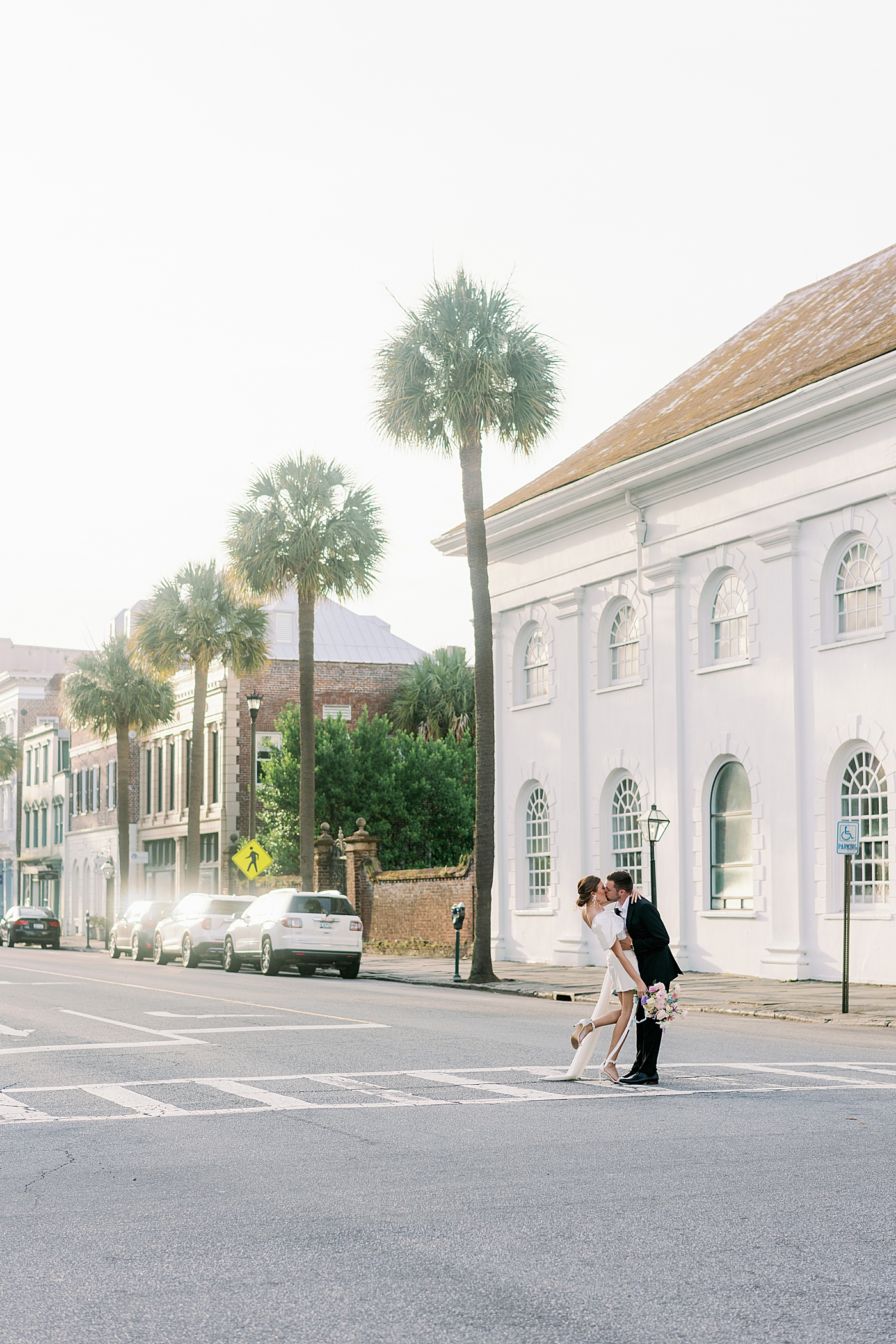 Bride and groom kissing at crosswalk during Elevated City Hall Elopement | Images by Annie Laura Photo