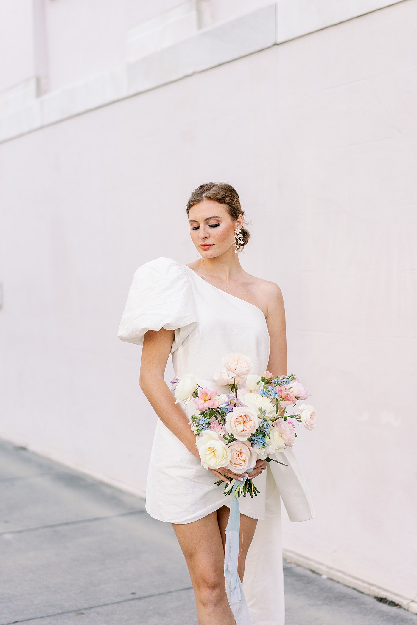 Bride in short gown holding pastel bouquet | Images by Annie Laura Photo