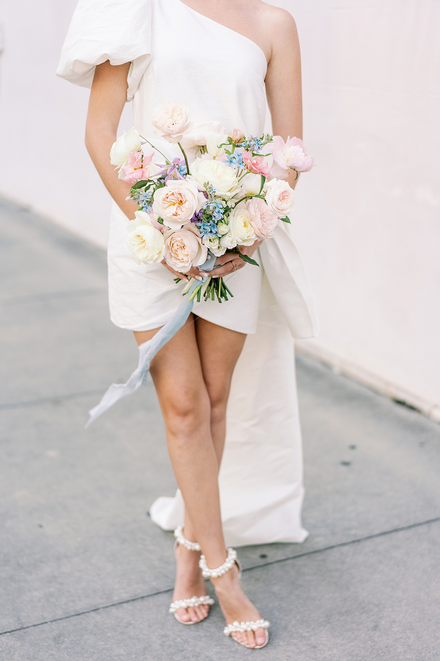 Detail of pastel bouquet held by bride in off shoulder gown | Images by Annie Laura Photo