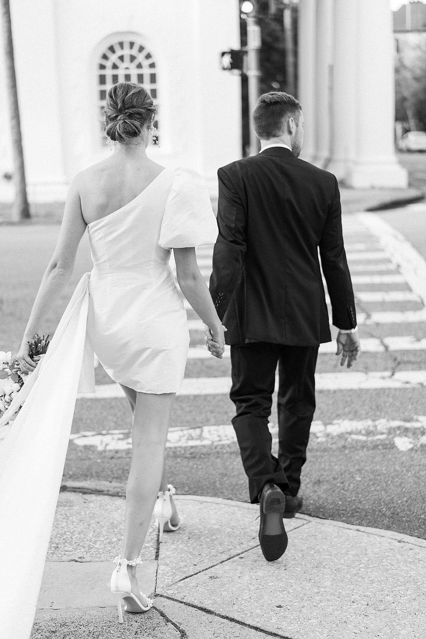 Black and white image of bride and groom crossing the street | Images by Annie Laura Photo