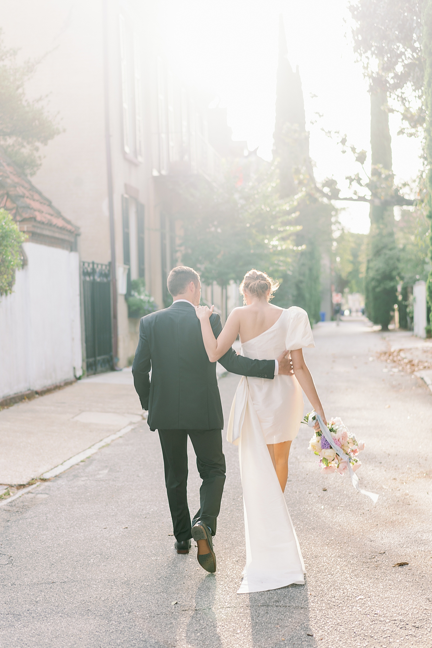 Bride and groom walking down a side street during Elevated City Hall Elopement | Images by Annie Laura Photo