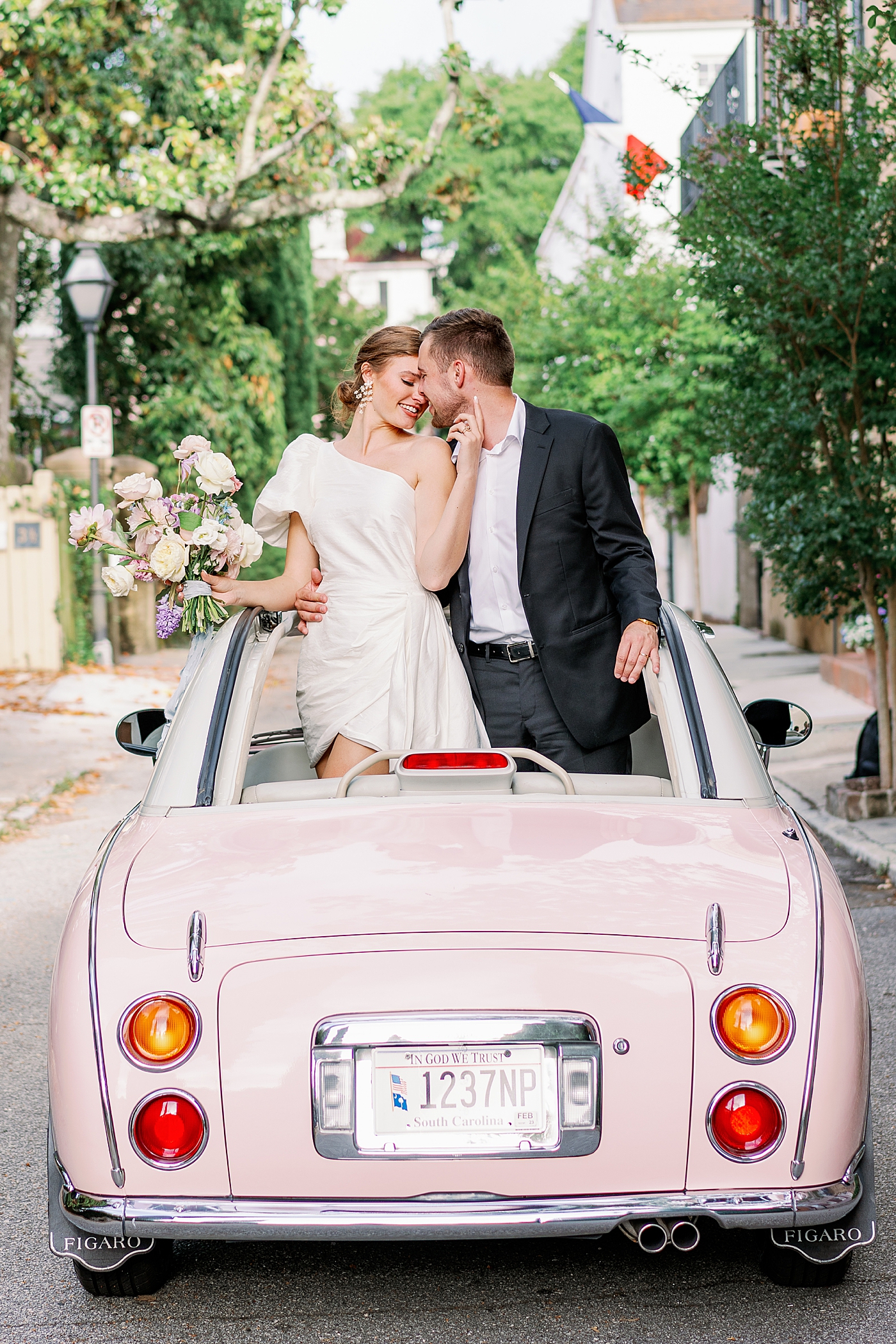 Bride and groom in pink convertible during Elevated City Hall Elopement in Charleston | Images by Annie Laura Photo