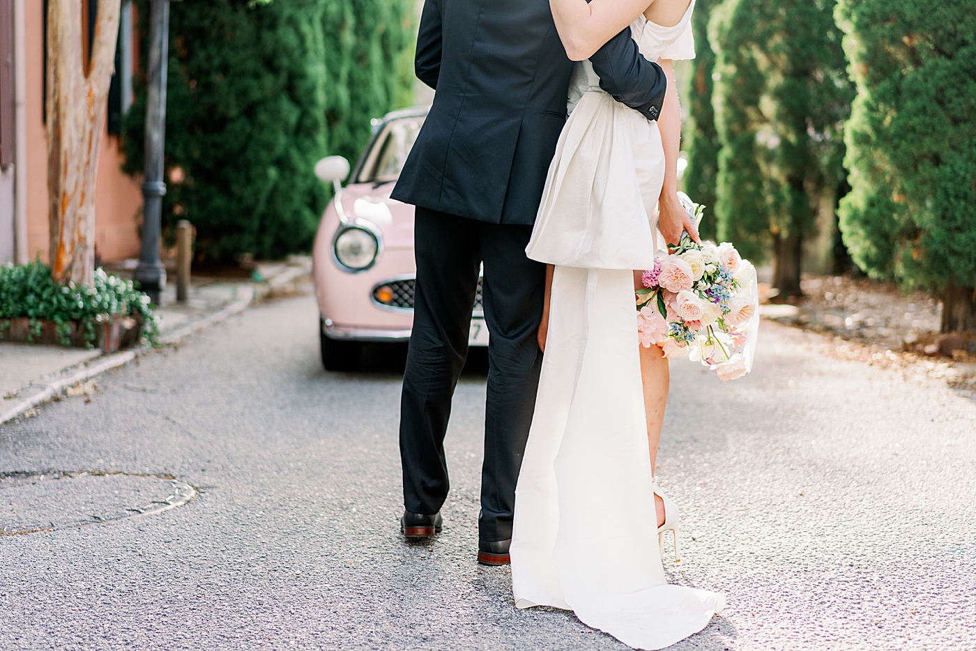 Detail of bride and groom near pink car | Images by Annie Laura Photo