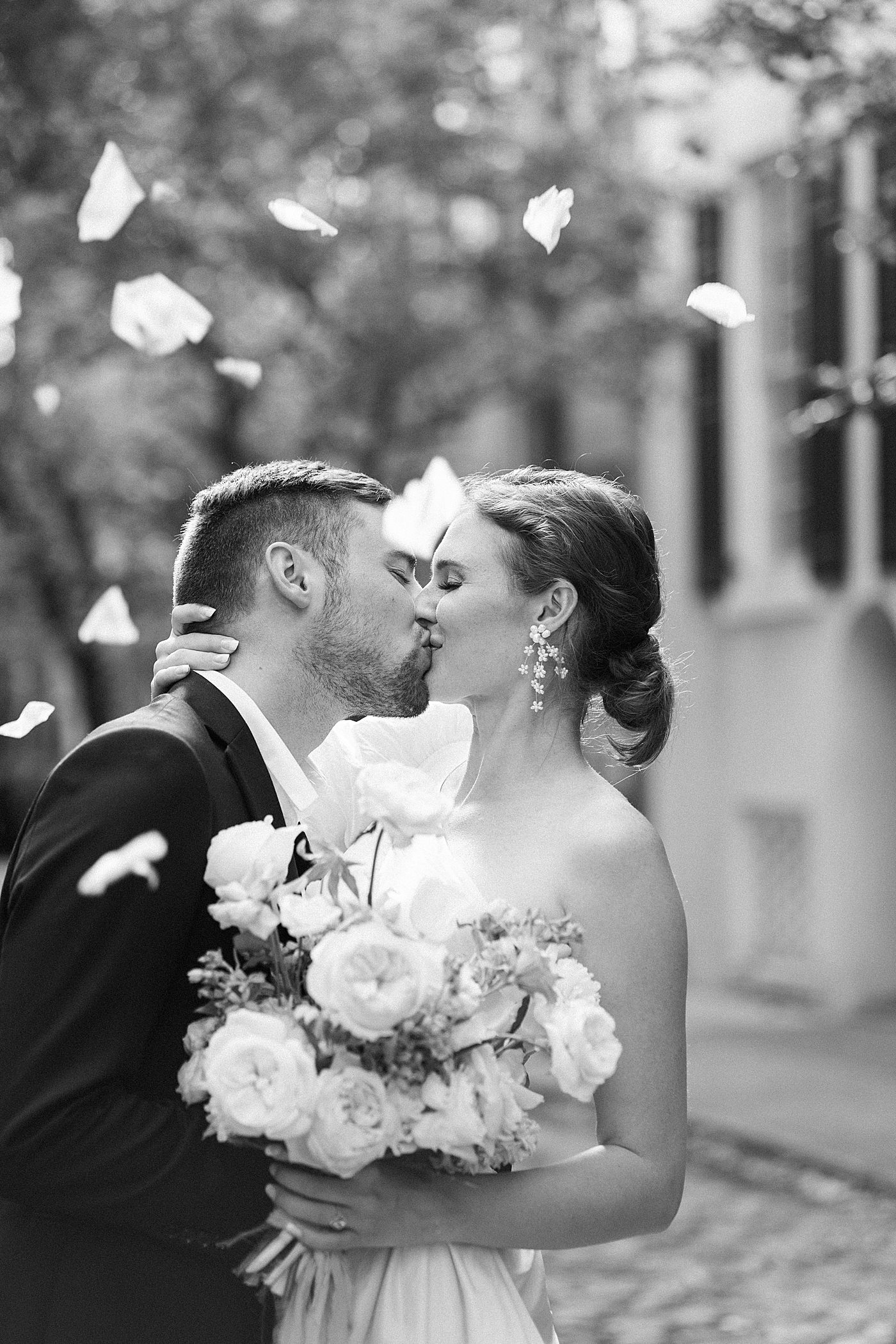 Black and white image of bride and groom kissing during Elevated City Hall Elopement in Charleston | Images by Annie Laura Photo