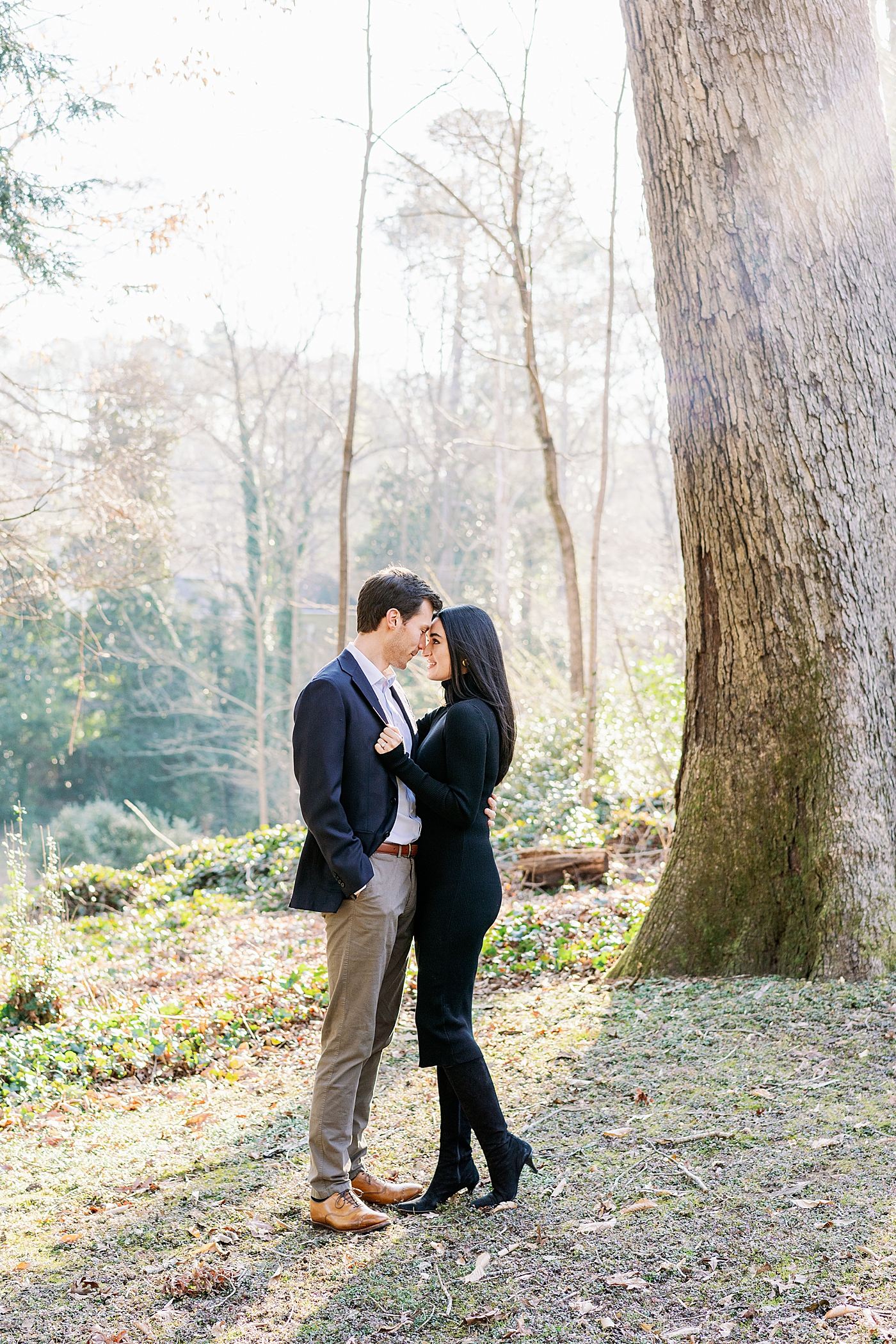 Couple in black and navy hugging in the woods | Image by Annie Laura Photo